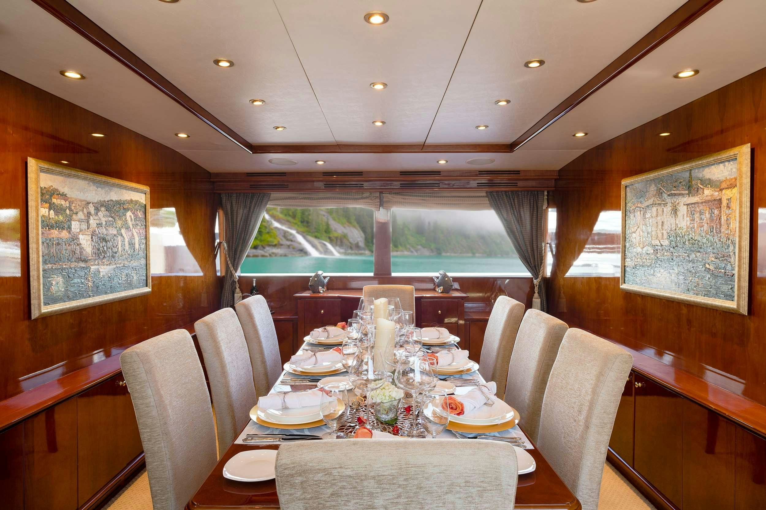 a dining room with a table set for a dinner aboard OUTTA TOUCH Yacht for Charter