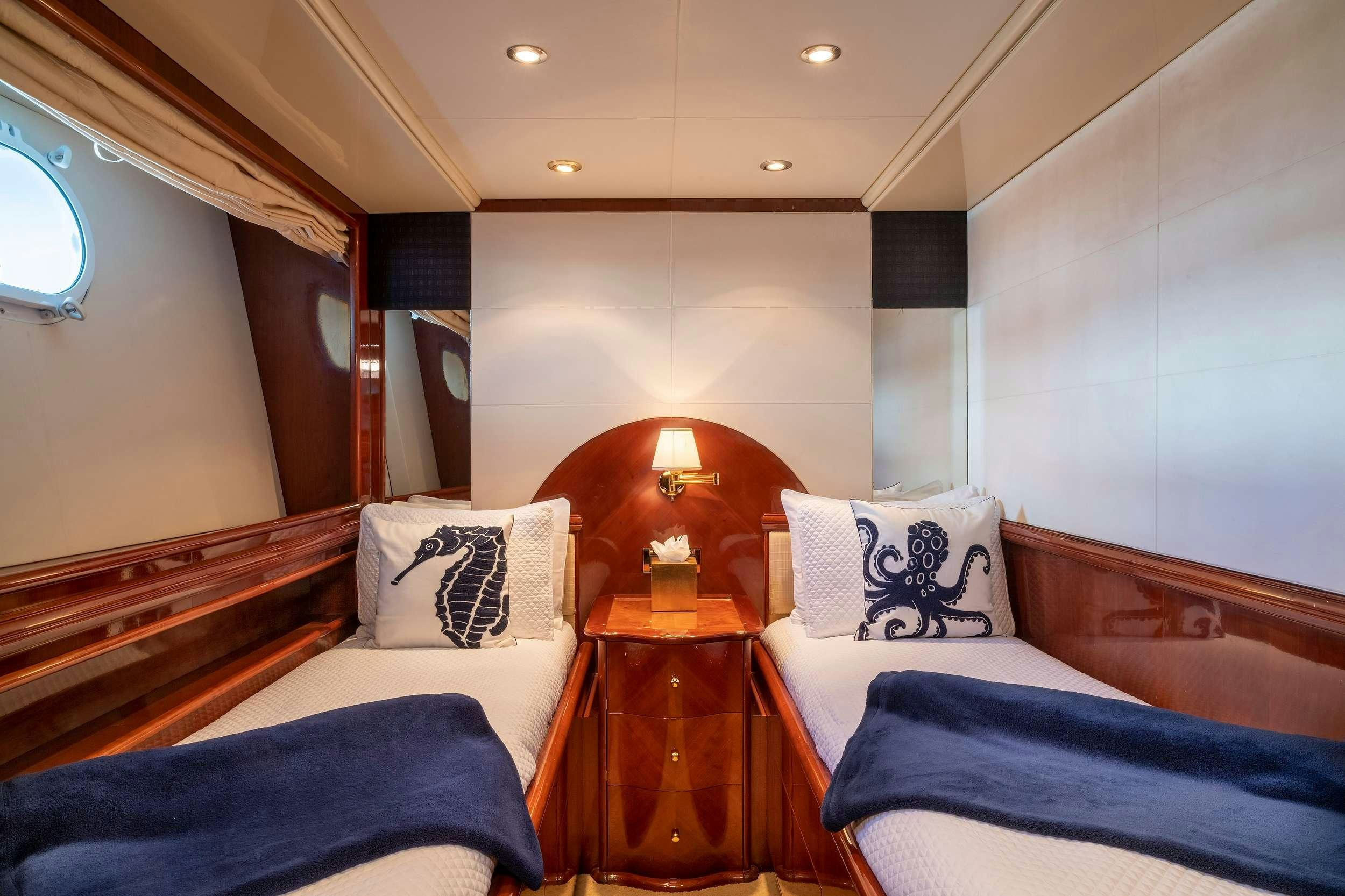 a room with a bed and a table aboard OUTTA TOUCH Yacht for Charter