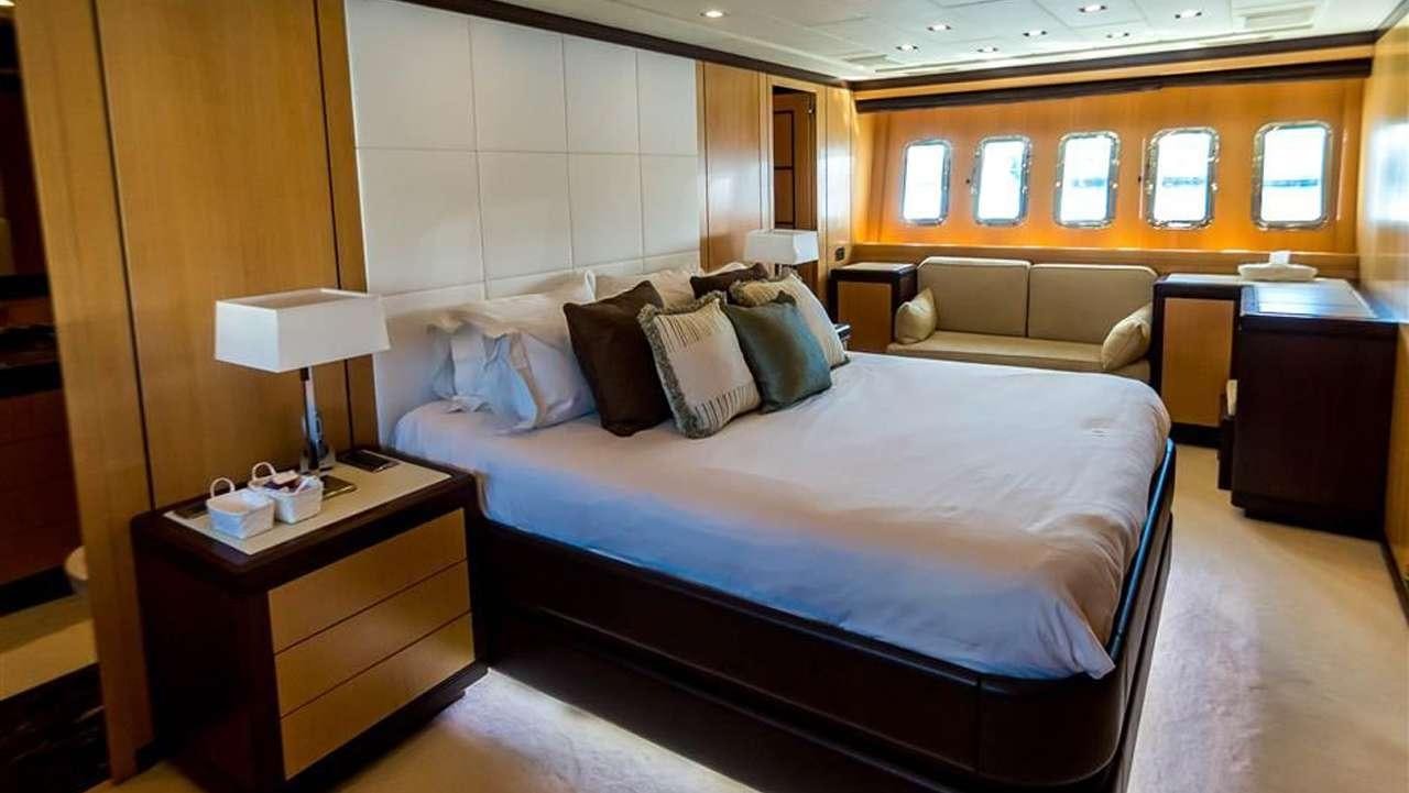 a room with a bed and a couch aboard DAYA Yacht for Charter