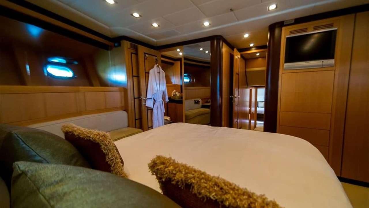 a room with a bed and a tv aboard DAYA Yacht for Charter
