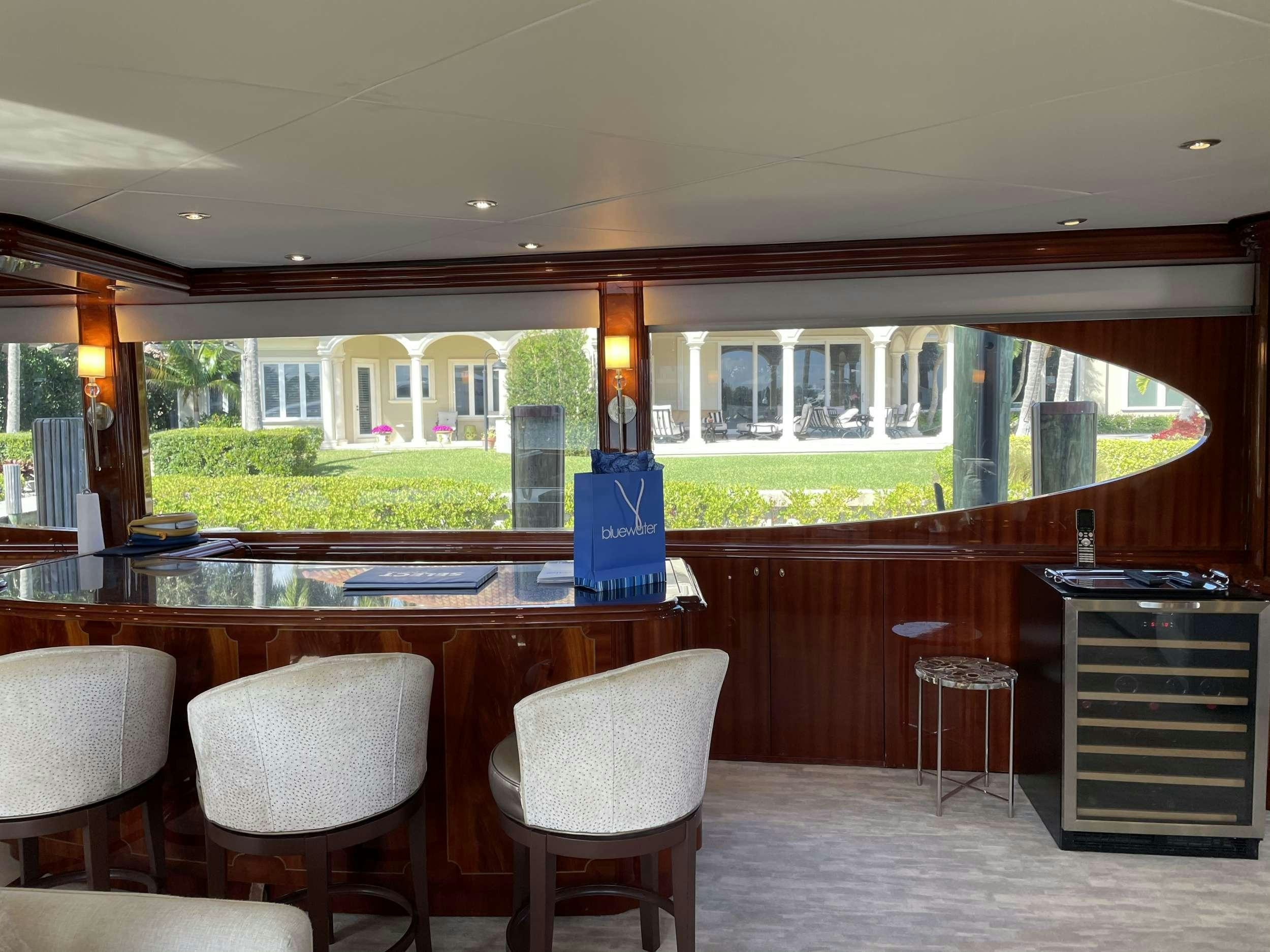 a large kitchen with a bar and chairs aboard Passion Yacht for Charter
