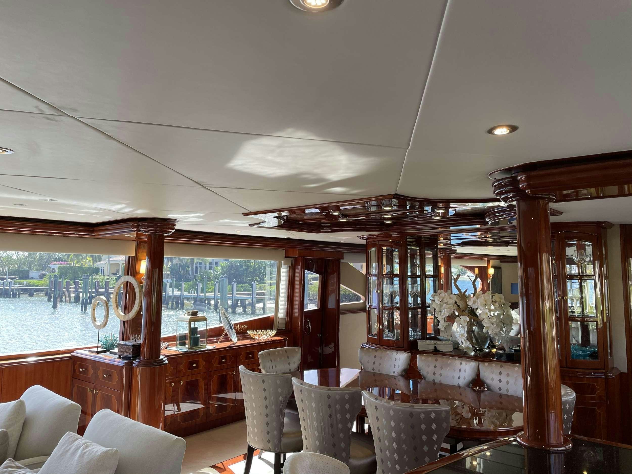 a room with a table chairs and a large window aboard Passion Yacht for Charter