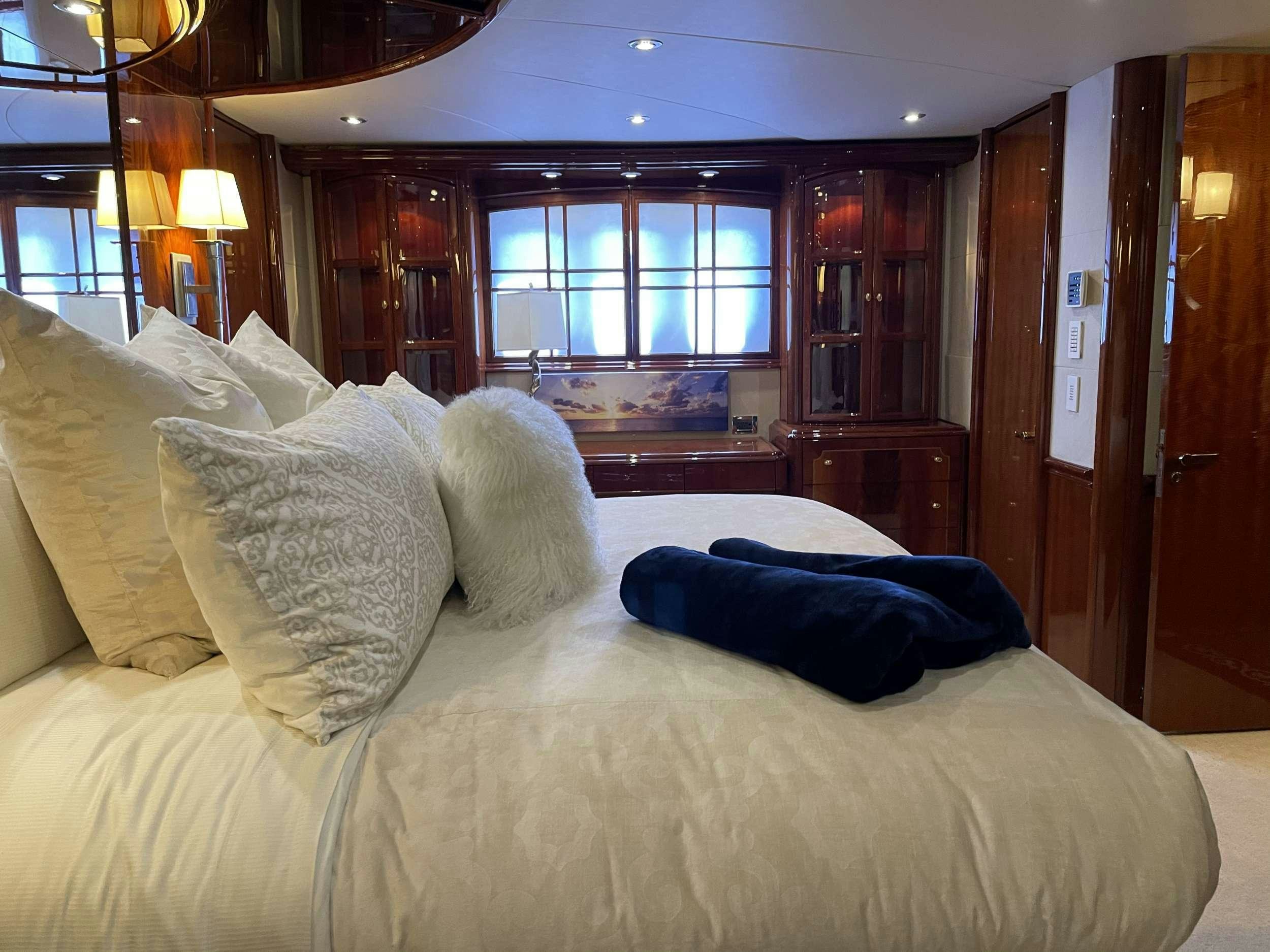 a bed with pillows aboard Passion Yacht for Charter