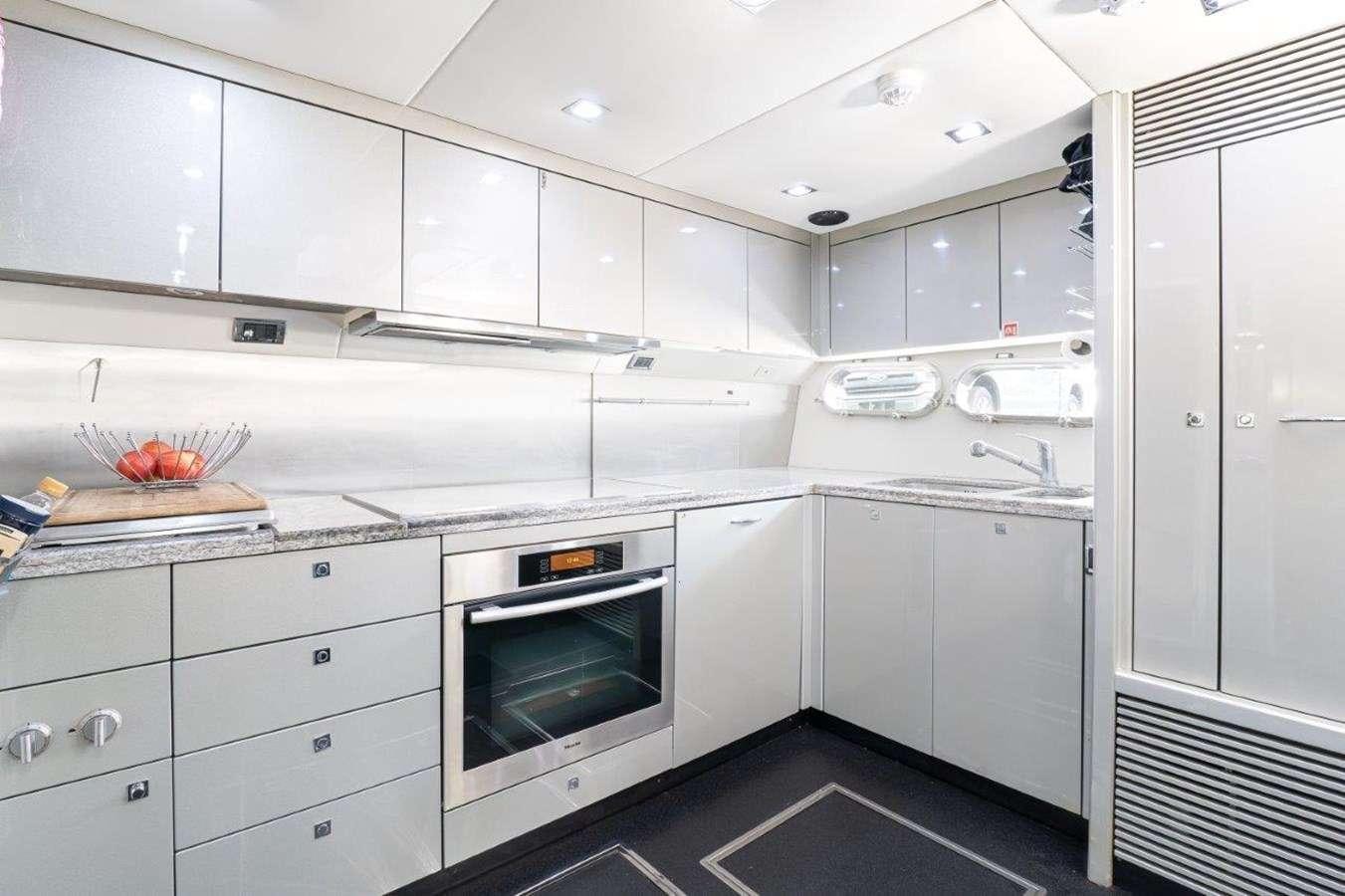 a kitchen with white cabinets aboard sky fall Yacht for Charter
