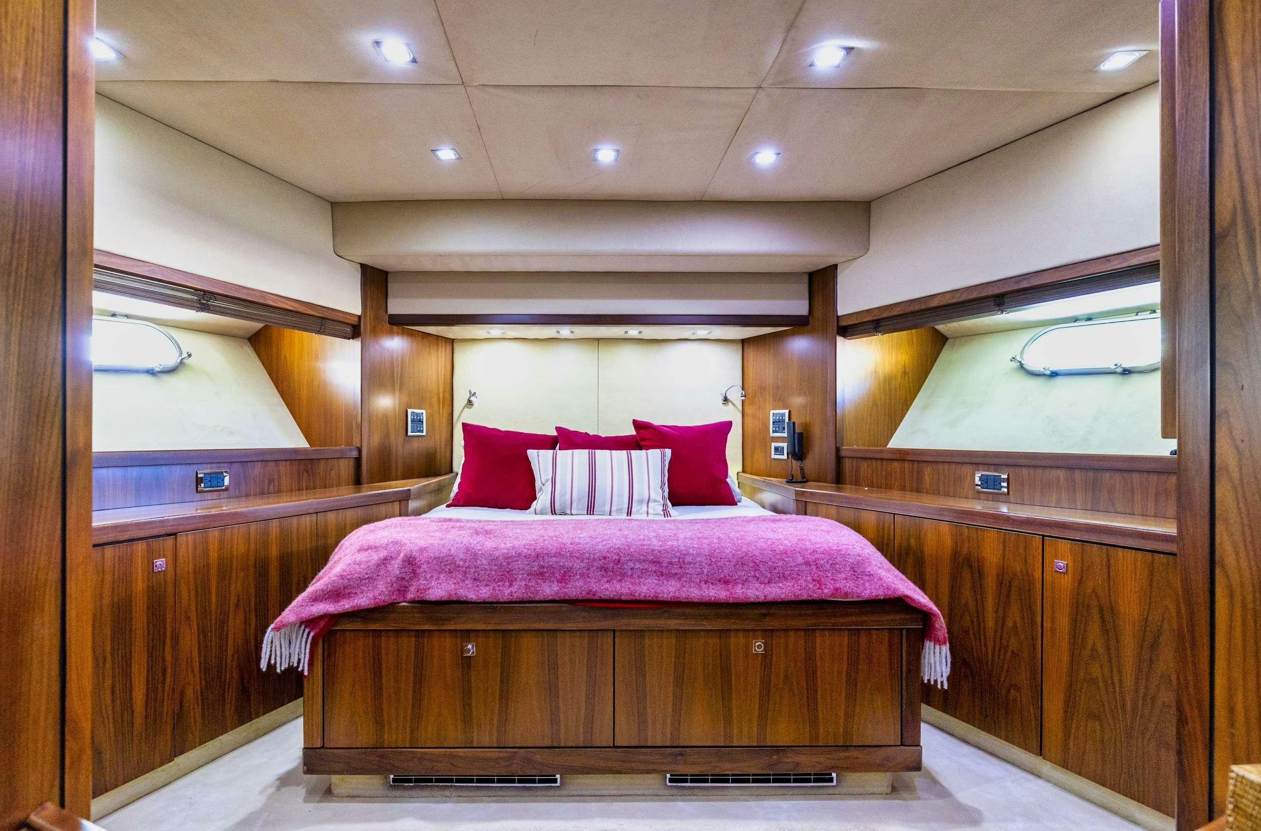 a bed in a room aboard sky fall Yacht for Charter