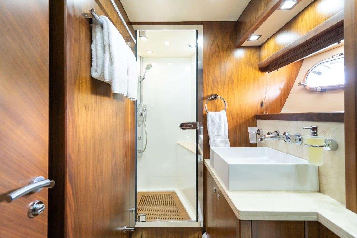 a bathroom with a sink and a mirror aboard sky fall Yacht for Charter