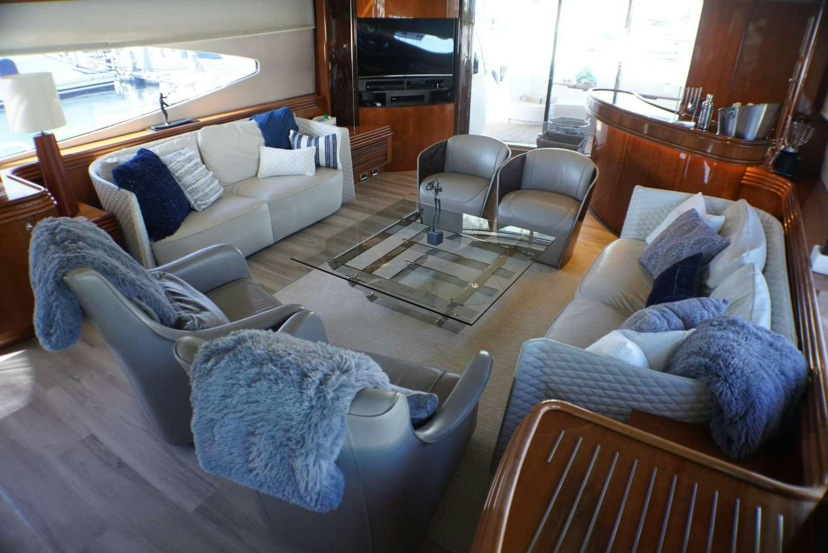 a living room with a couch and a coffee table aboard YCM 105 Yacht for Charter
