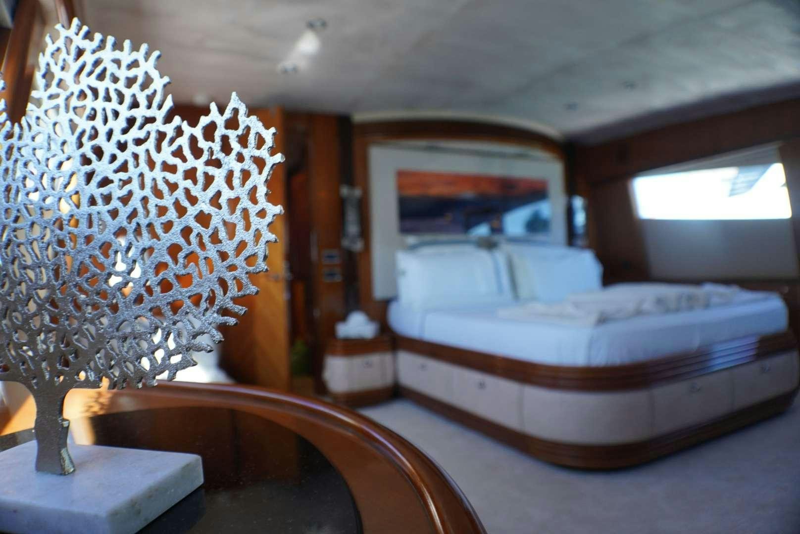 a room with a bed and a mirror aboard YCM 105 Yacht for Charter