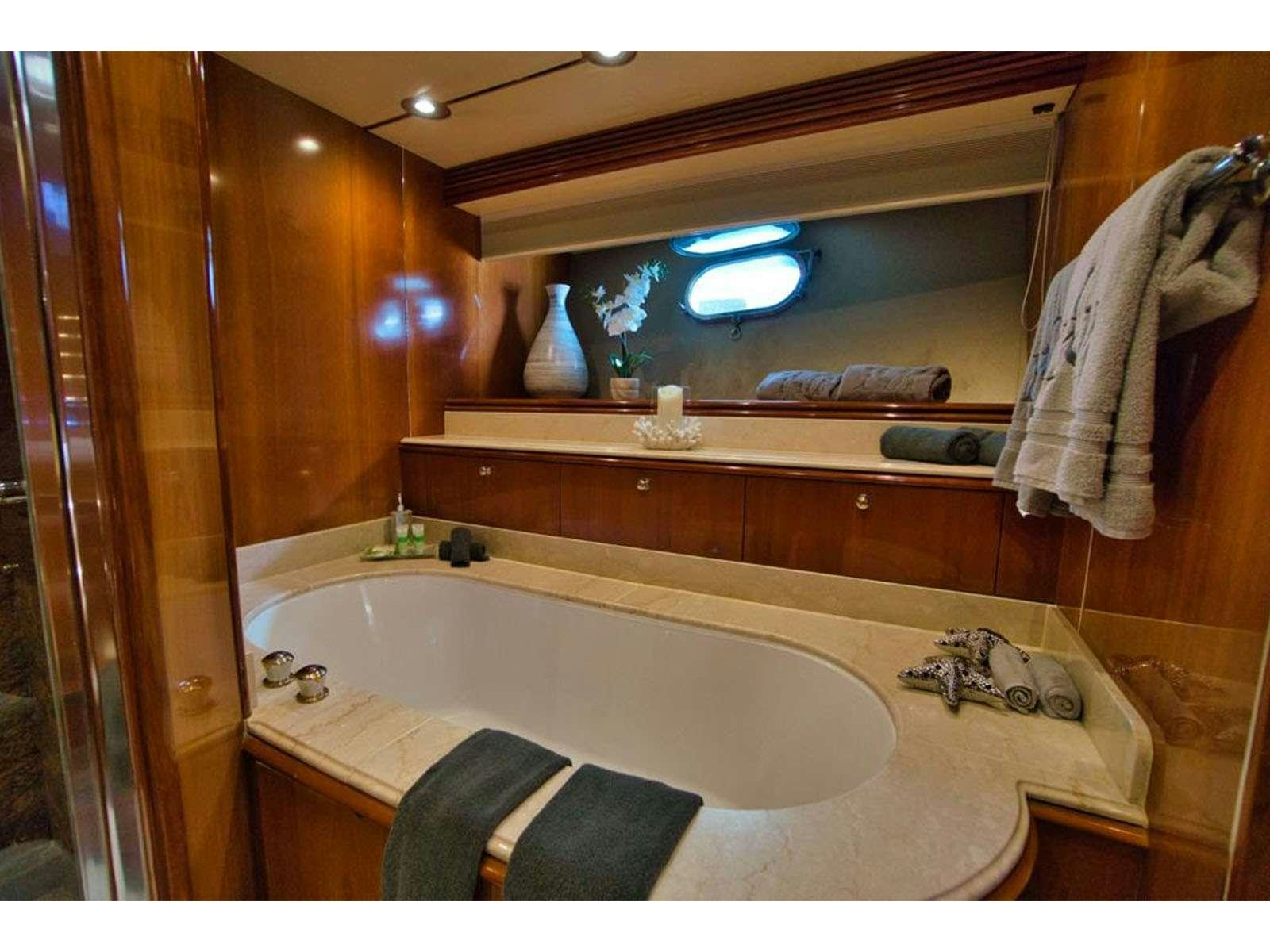 a bathroom with a large bathtub aboard YCM 105 Yacht for Charter