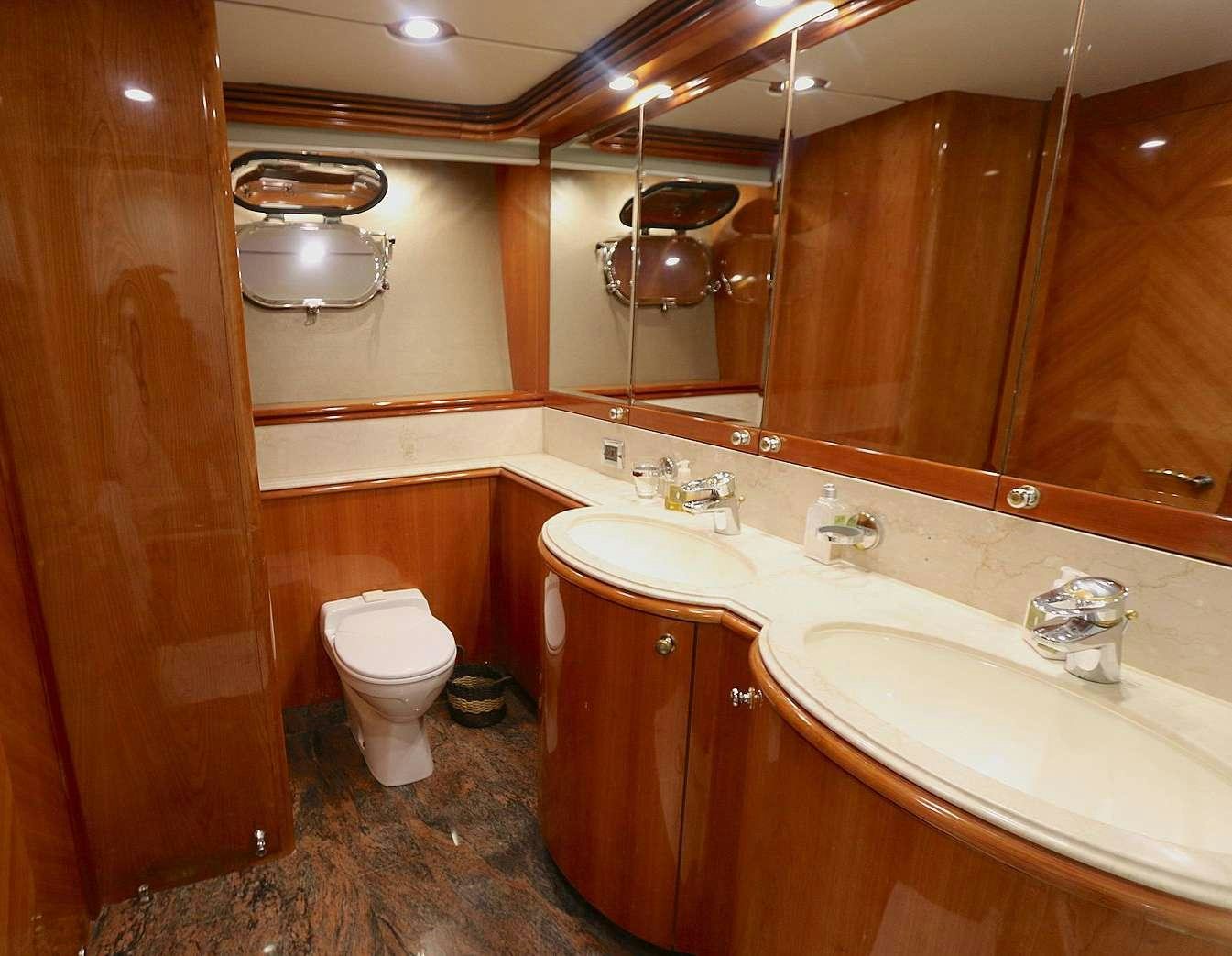 a bathroom with a large mirror aboard YCM 105 Yacht for Charter
