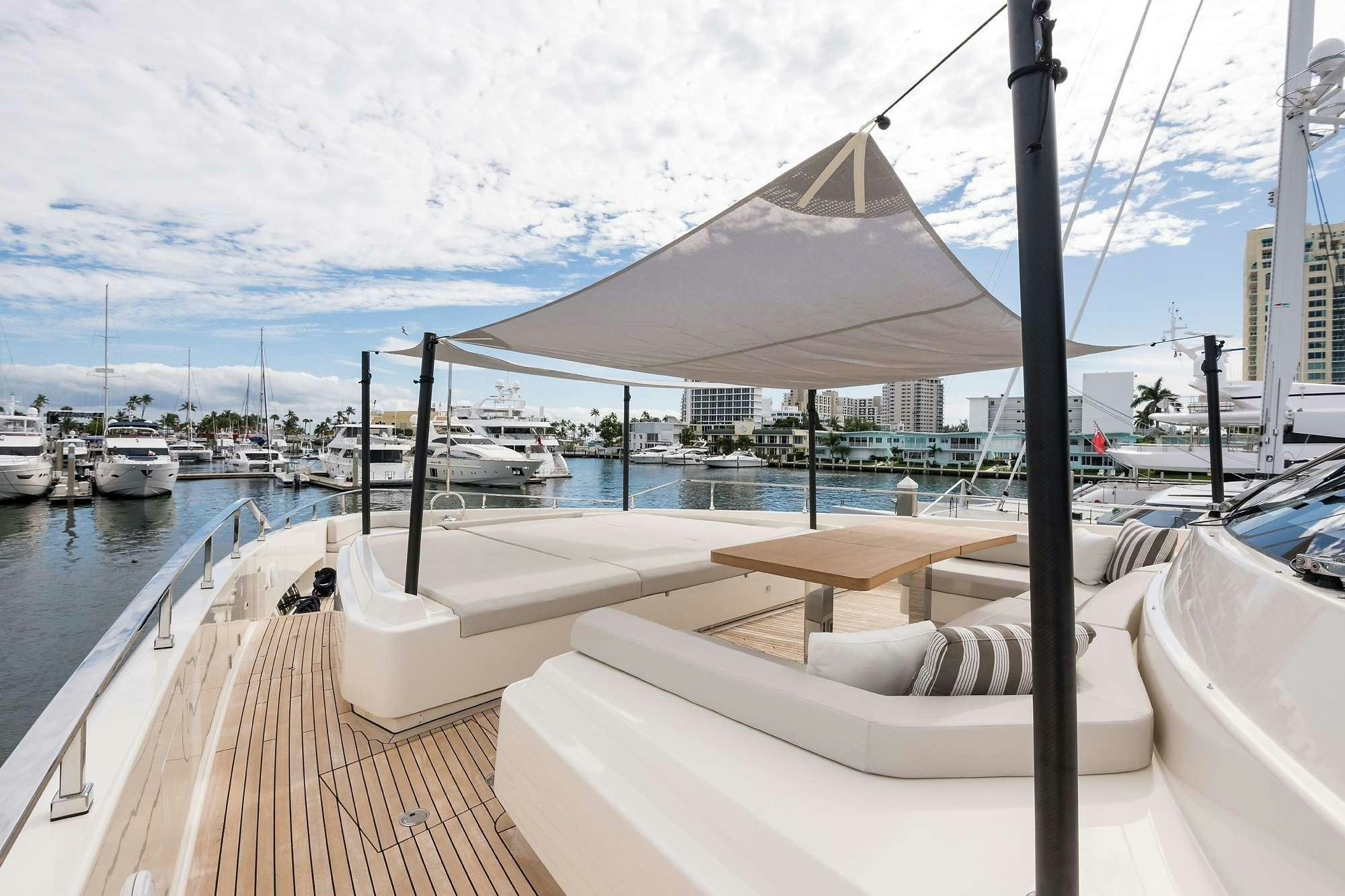 a deck with a covered area and boats in the water aboard GIOIA Yacht for Charter