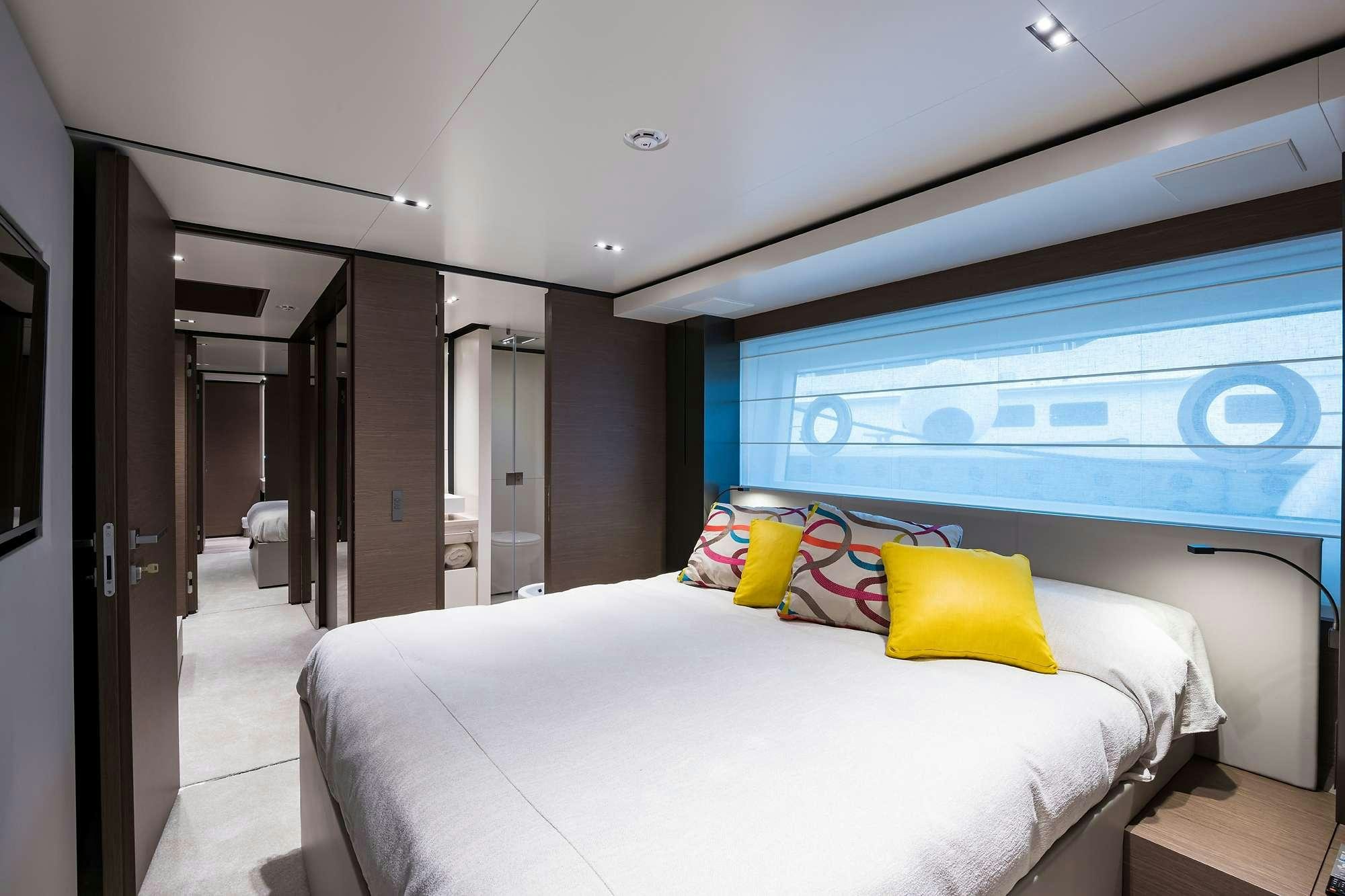 a room with a bed and a large screen aboard GIOIA Yacht for Charter