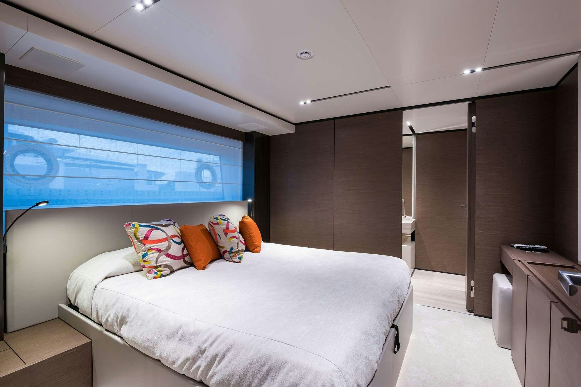 a bedroom with a bed and a window aboard GIOIA Yacht for Charter