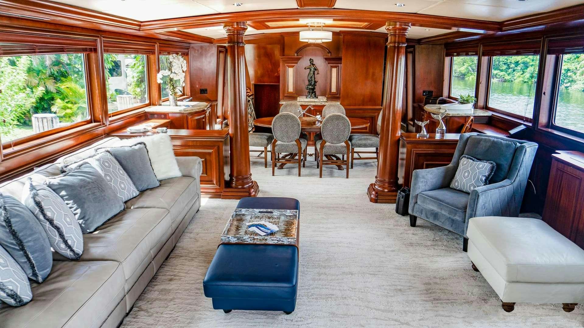 a living room with a couch and a table aboard THREE KINGS Yacht for Charter