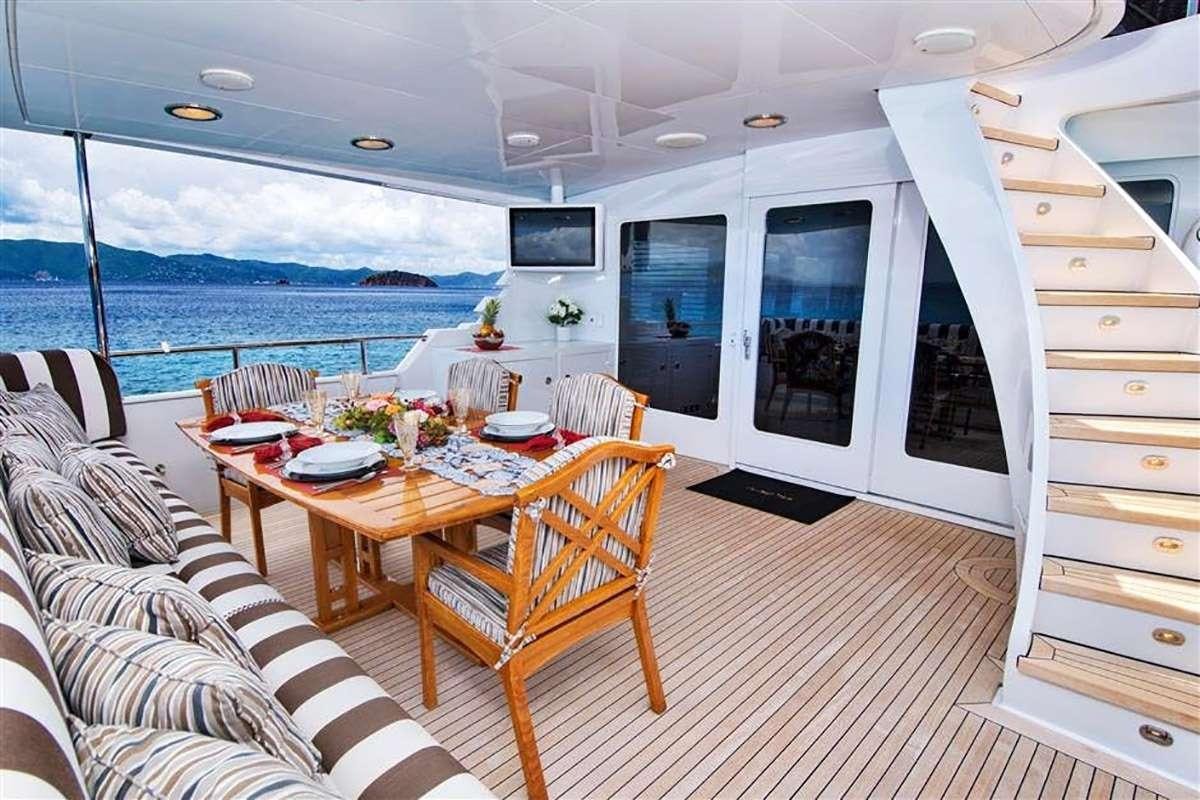 a room with a table and chairs aboard THREE KINGS Yacht for Charter