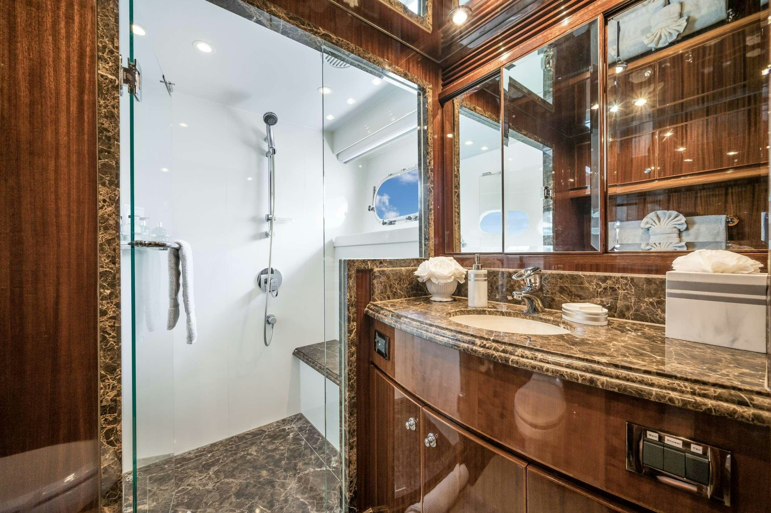 a bathroom with a large mirror aboard LIMITLESS Yacht for Charter