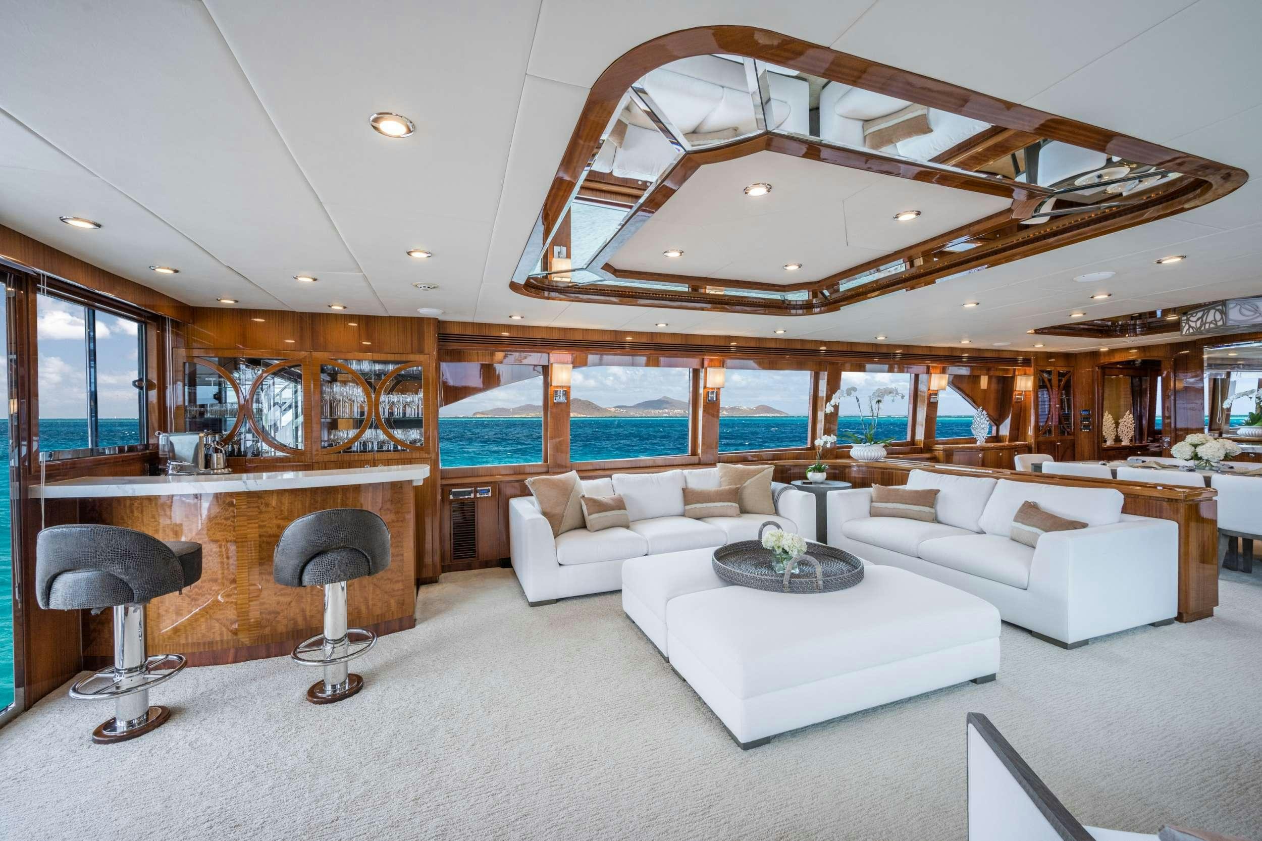 a large living room with a large open roof aboard LIMITLESS Yacht for Charter