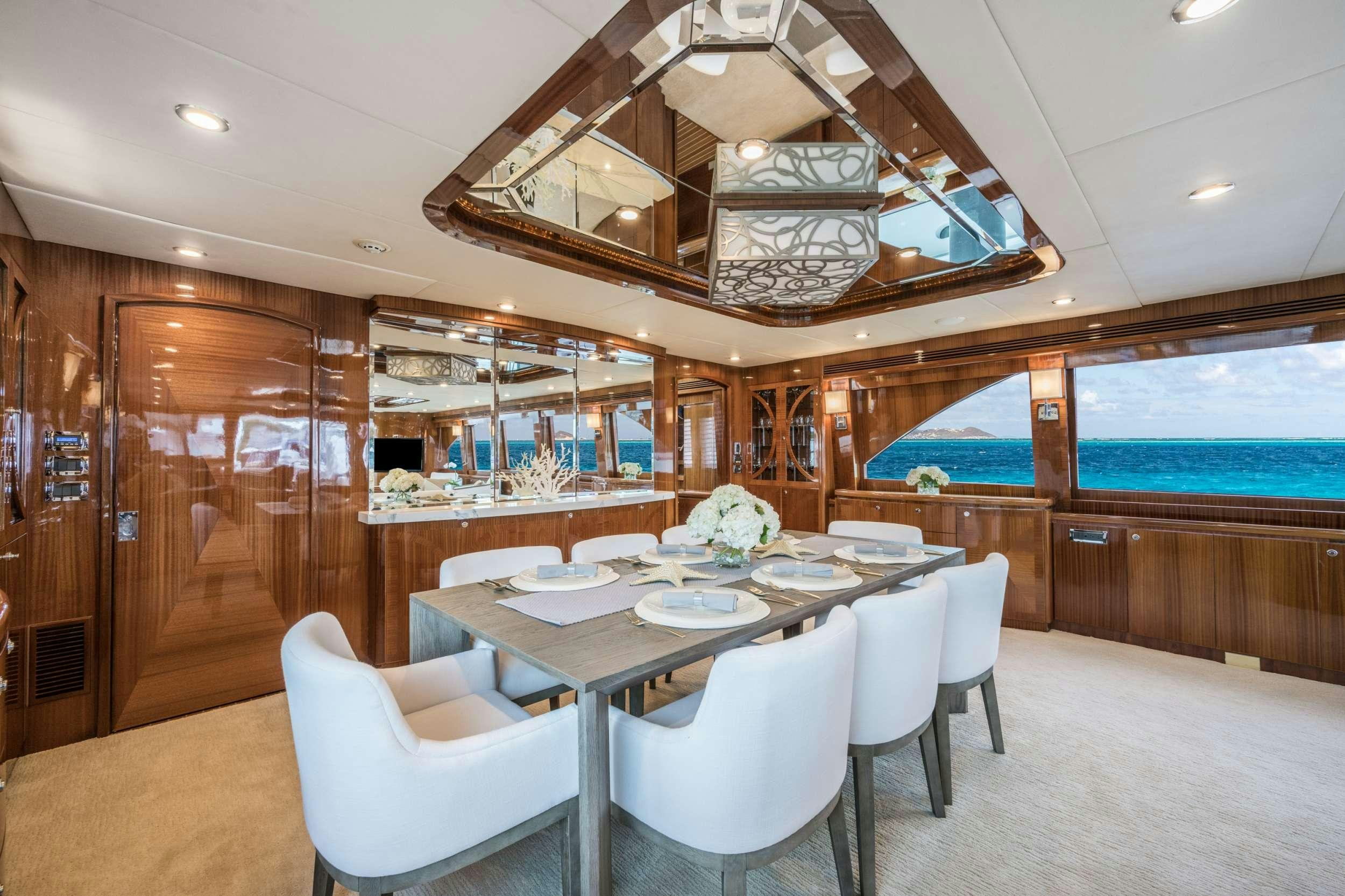 a dining room with a table and chairs aboard LIMITLESS Yacht for Charter