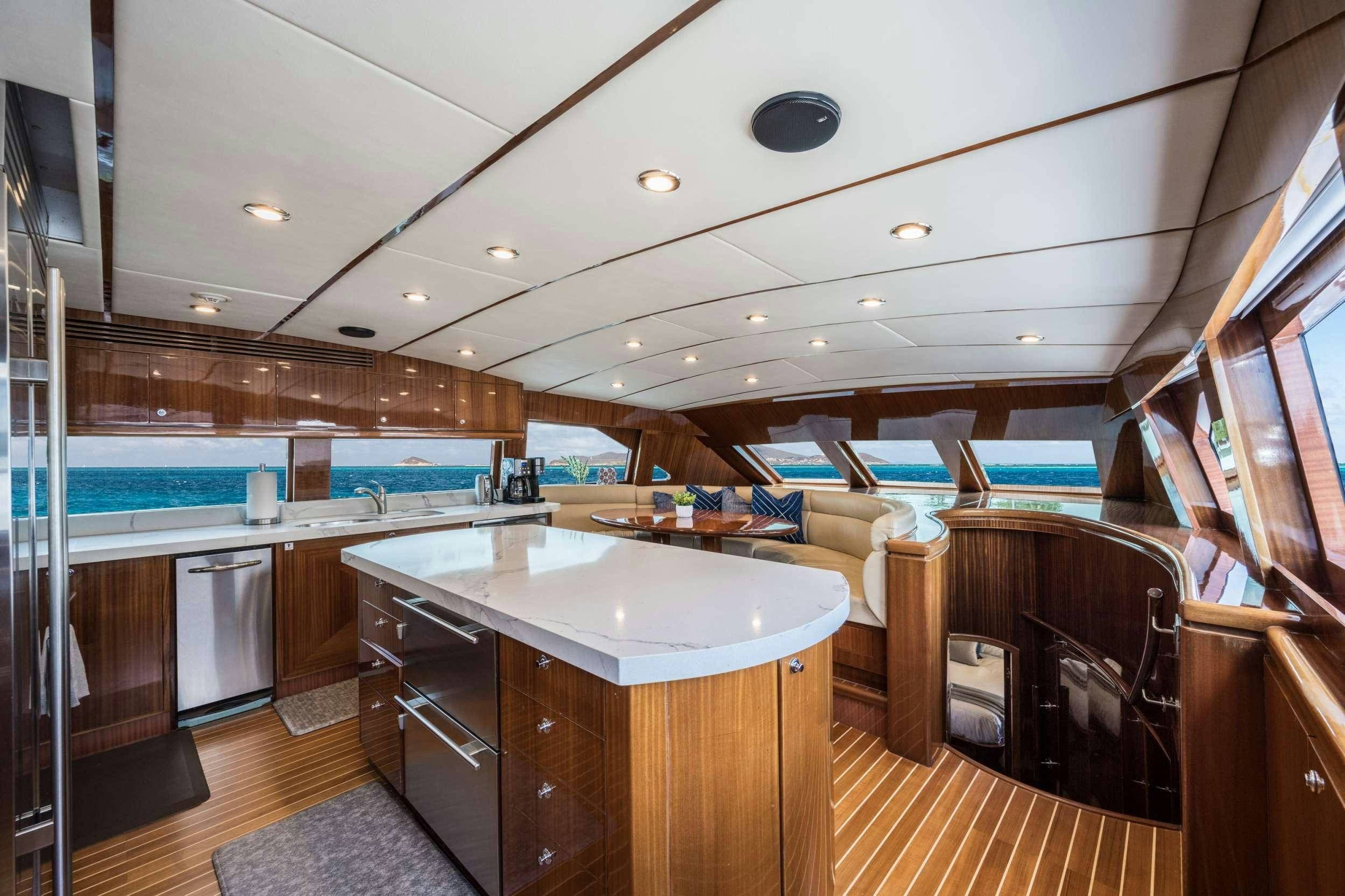a kitchen and living room aboard LIMITLESS Yacht for Charter