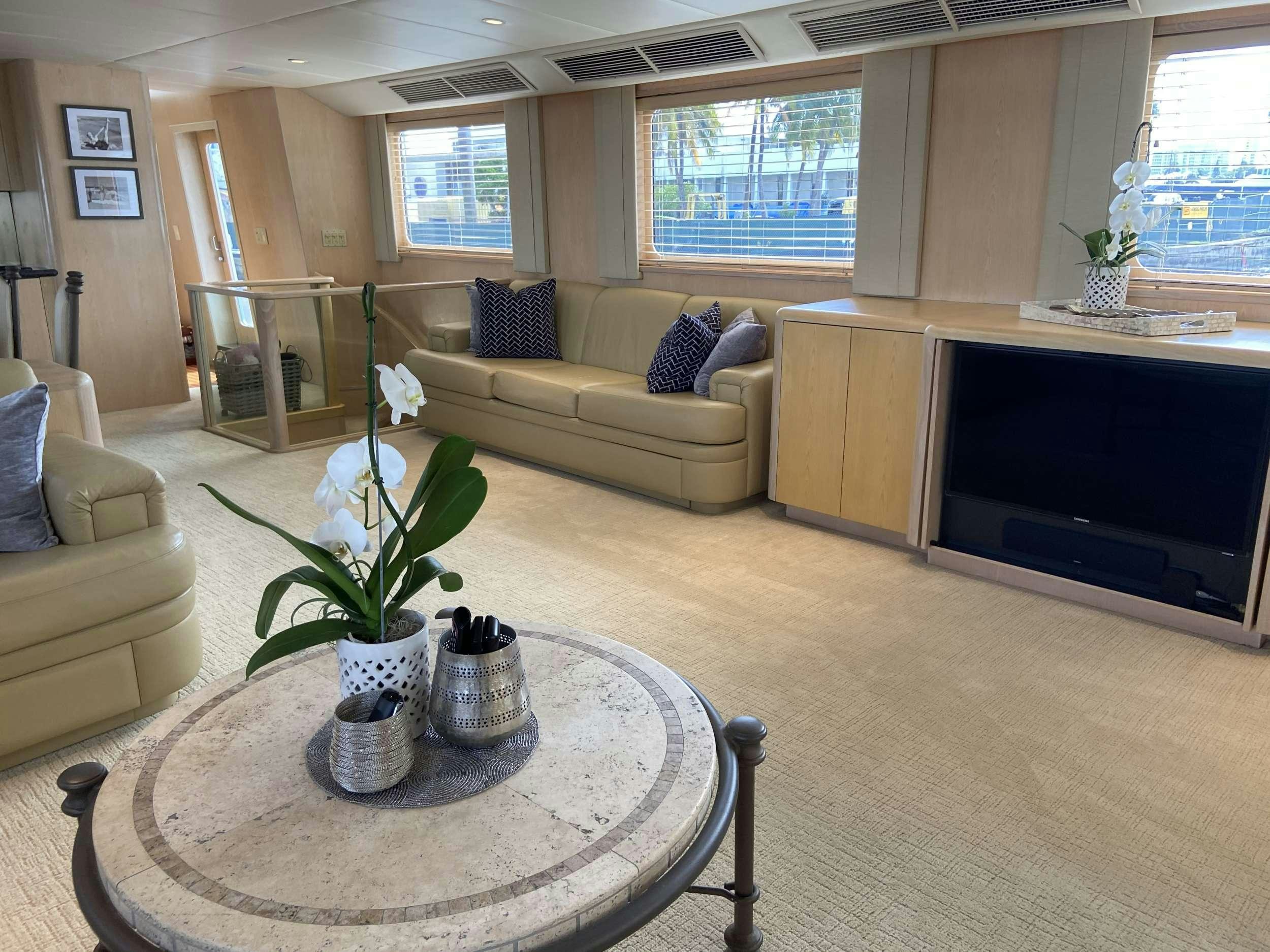a living room with a table and couches aboard LADY GRAY Yacht for Charter