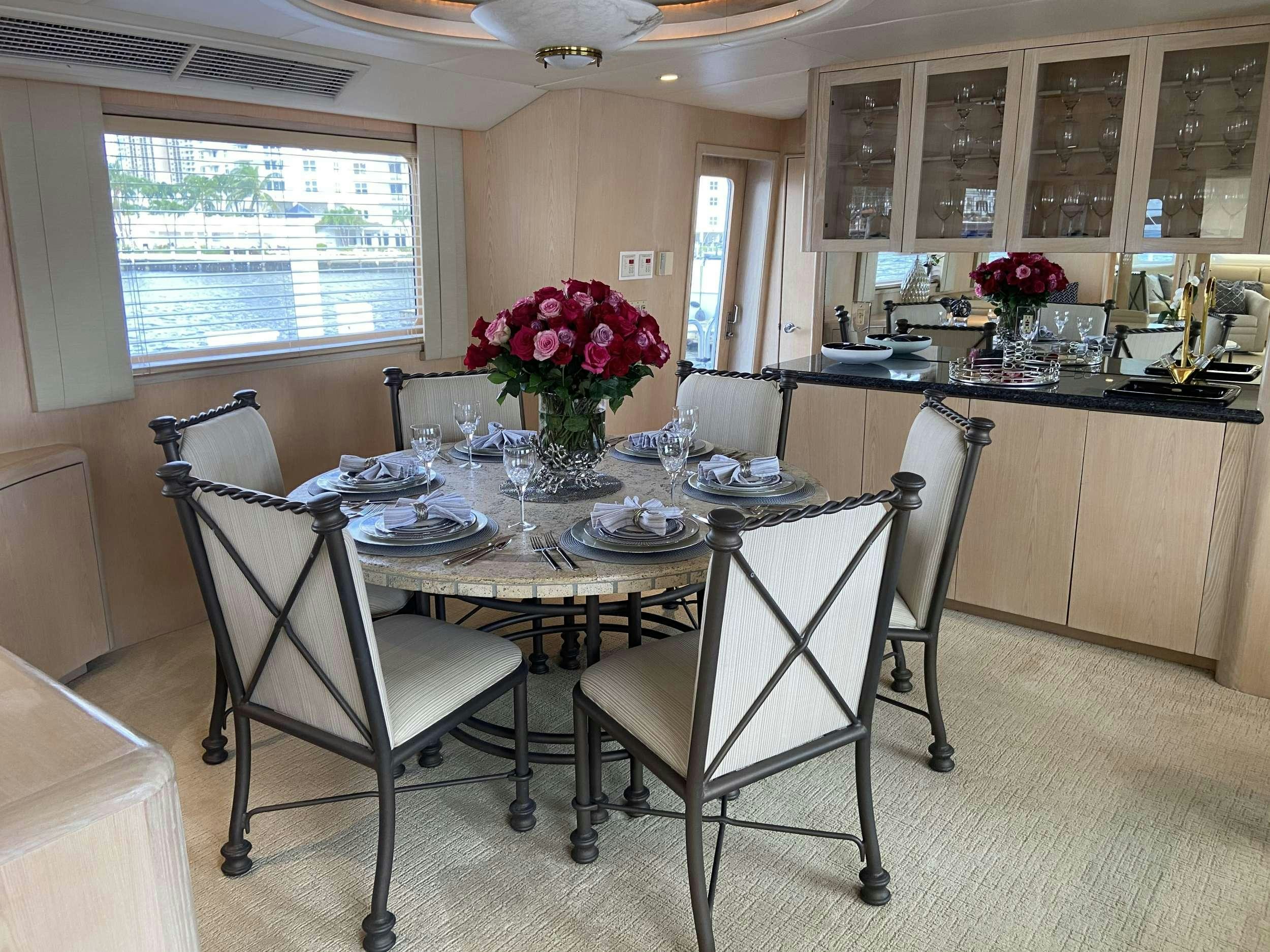 a dining room with a table and chairs aboard LADY GRAY Yacht for Charter