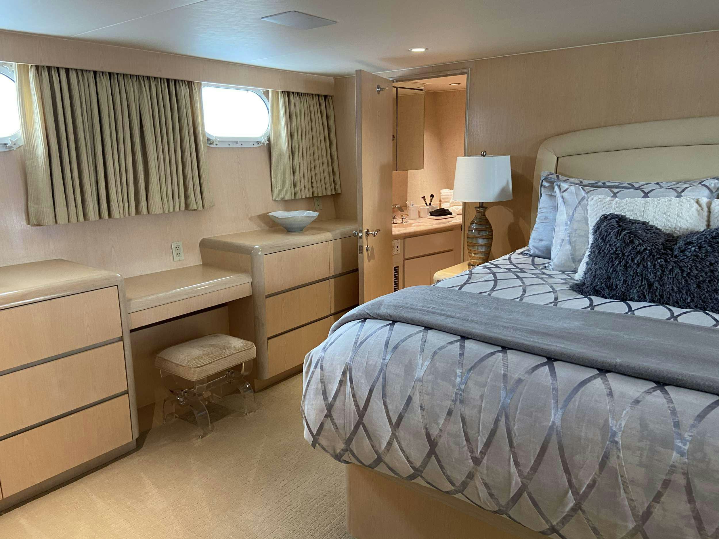 a bedroom with a bed and a dresser aboard LADY GRAY Yacht for Charter