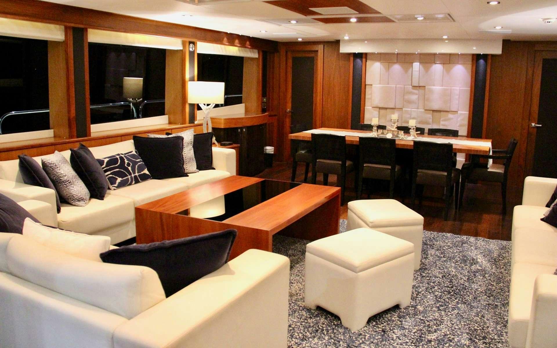 a room with a couch and a table and chairs aboard EMRYS Yacht for Charter
