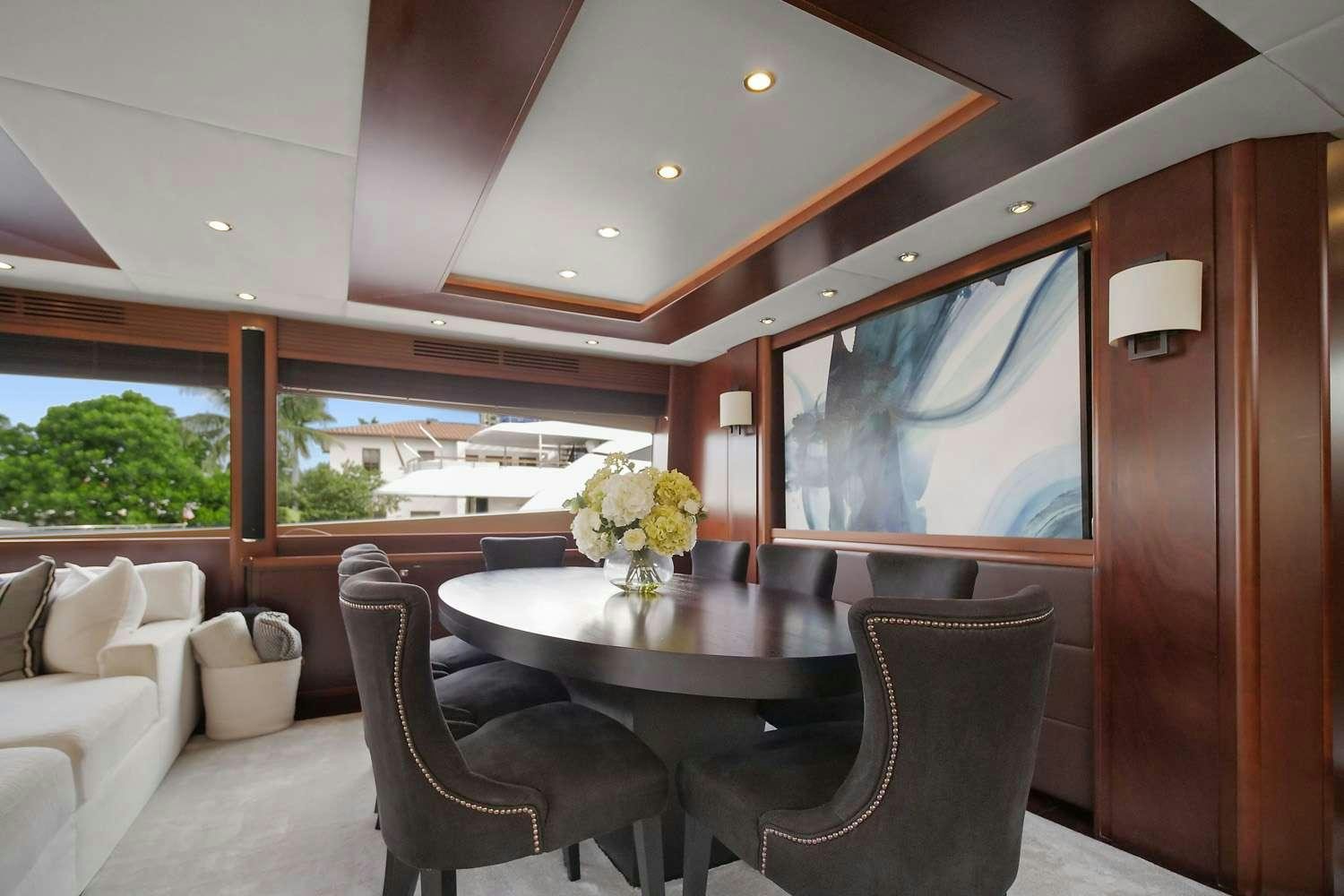 a dining table in a room aboard 21 SEA SANDS Yacht for Charter