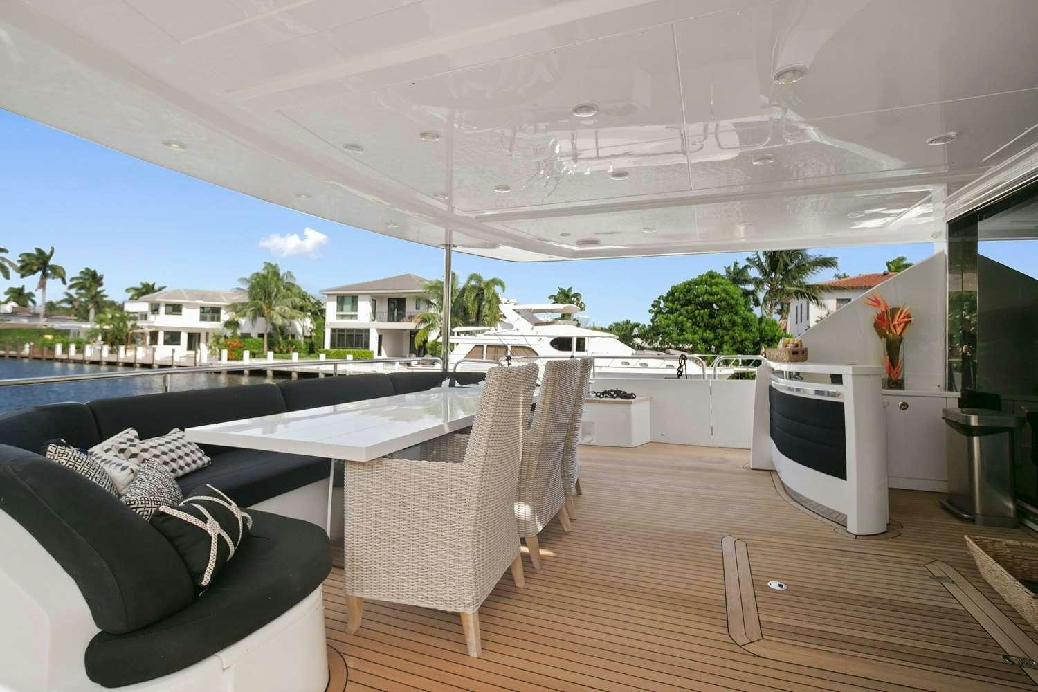 a room with a deck and a television aboard 21 SEA SANDS Yacht for Charter