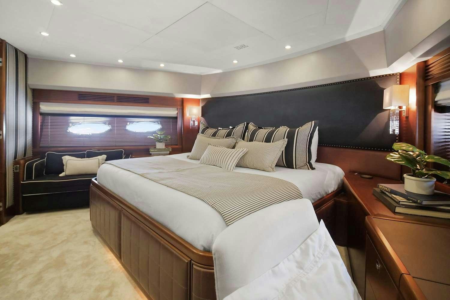 a hotel room with a bed and a couch aboard 21 SEA SANDS Yacht for Charter
