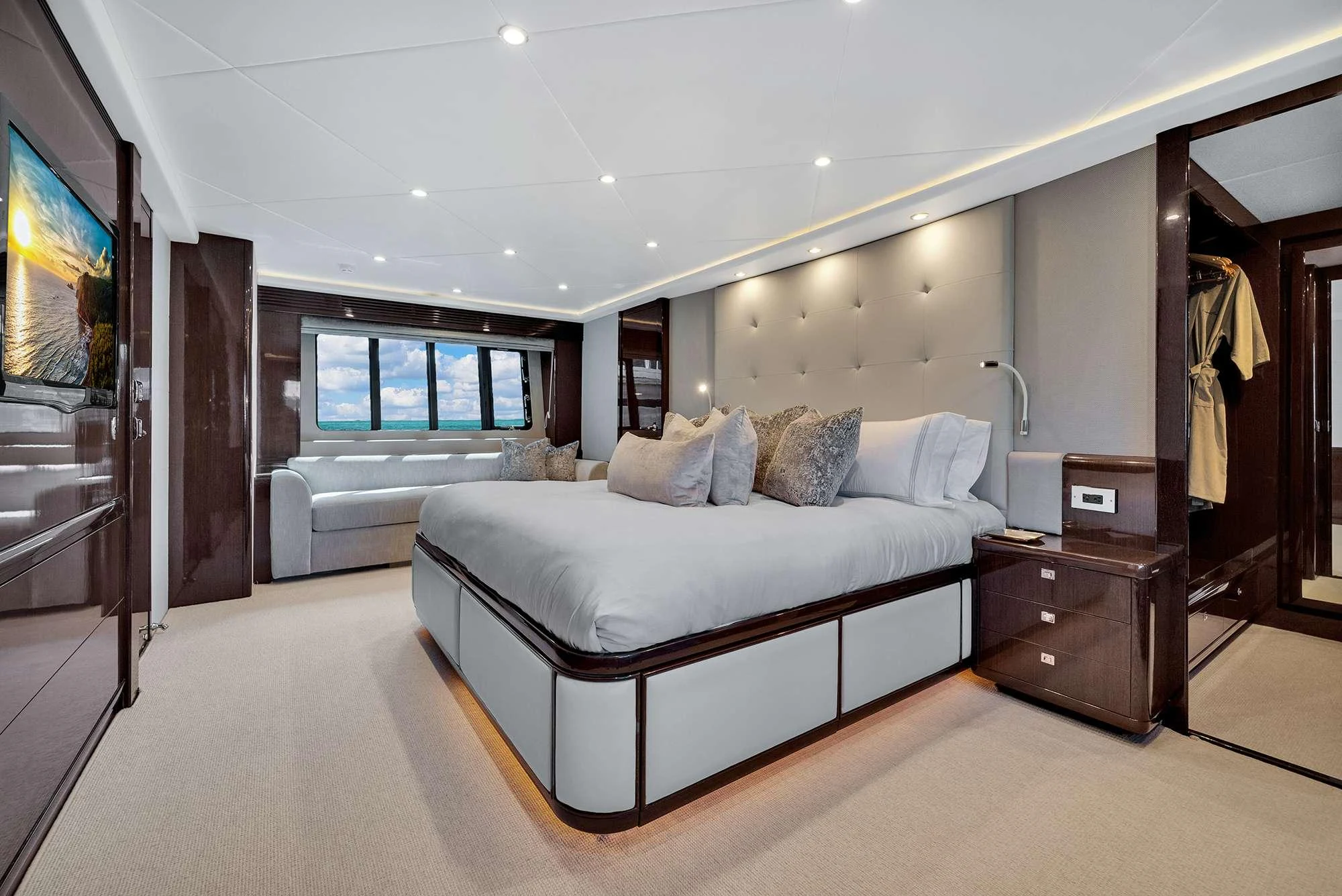 a bedroom with a bed and a desk aboard CURRENT $EA Yacht for Charter
