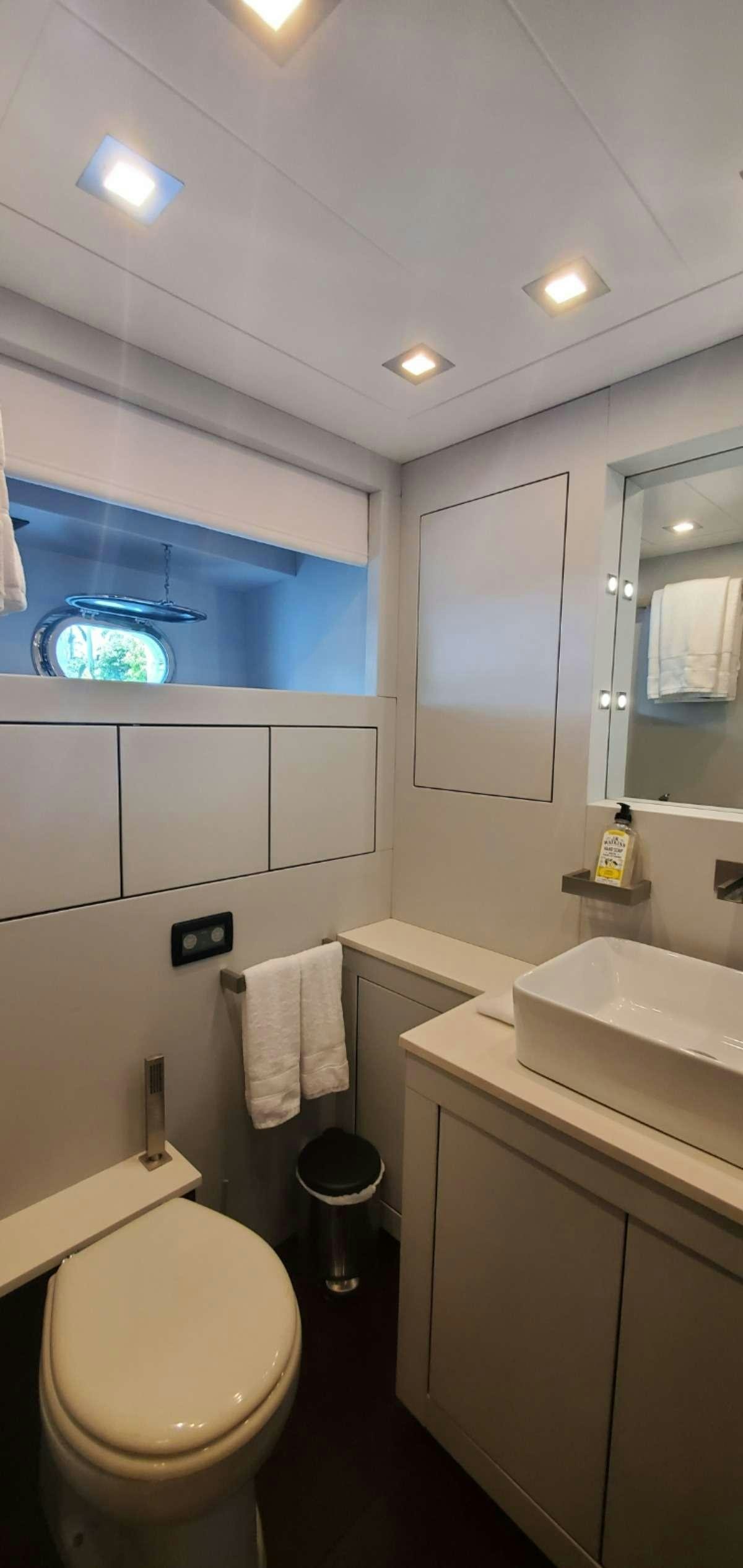 a bathroom with a toilet and a sink aboard HOUDINI Yacht for Charter