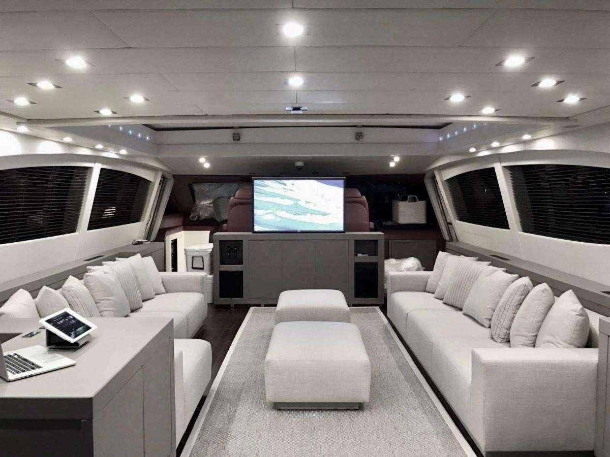 a room with a couch and a tv aboard HOUDINI Yacht for Charter