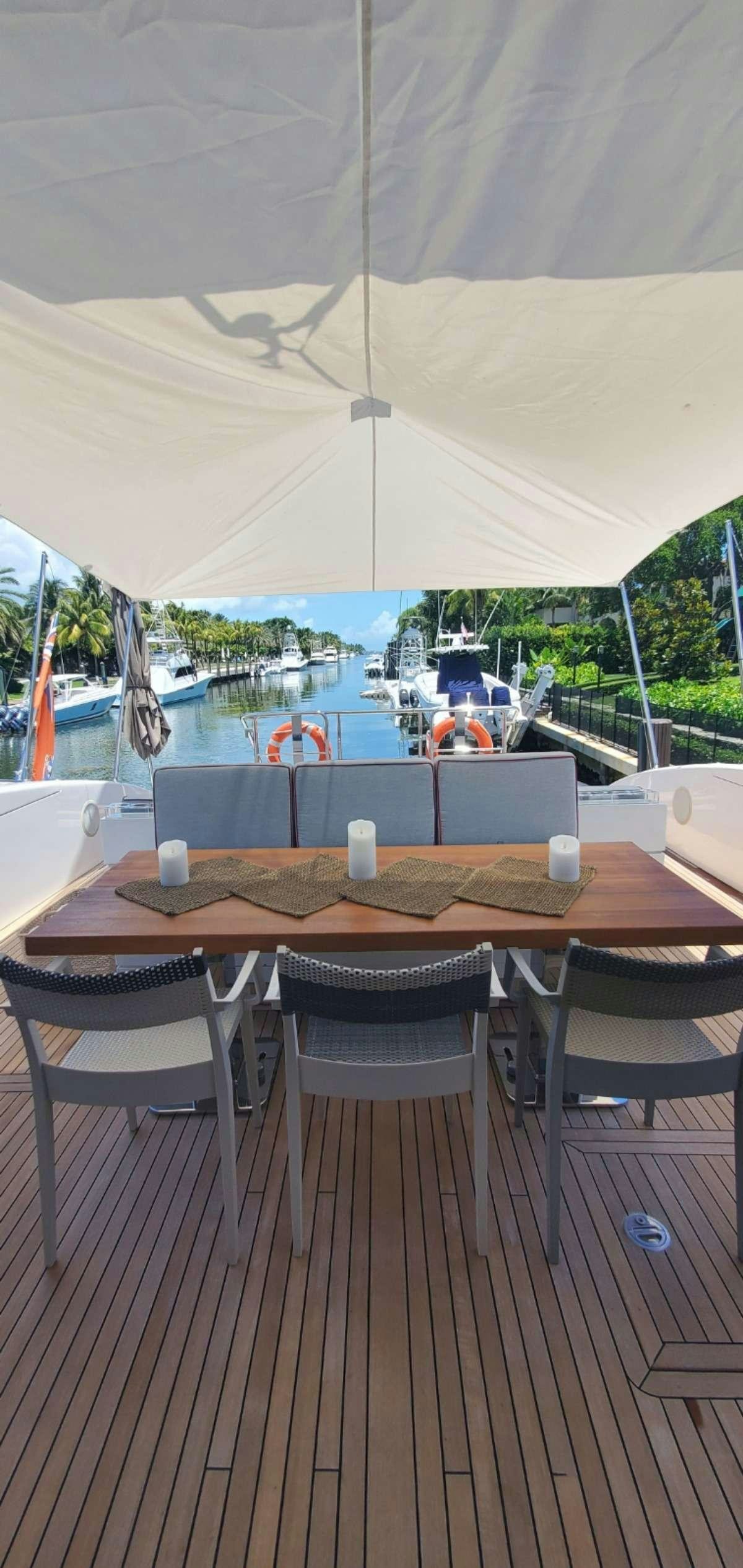 a table with chairs around it aboard HOUDINI Yacht for Charter
