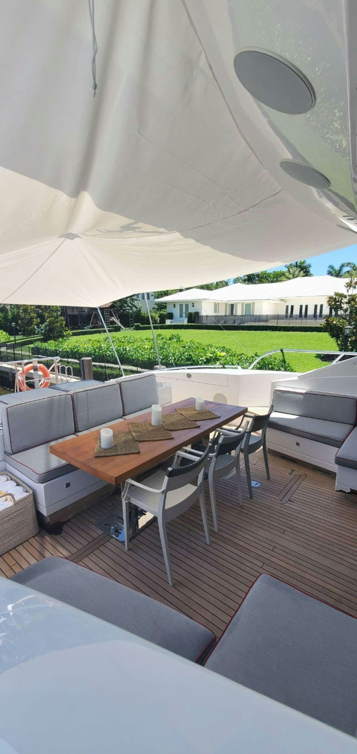 a table and chairs outside aboard HOUDINI Yacht for Charter