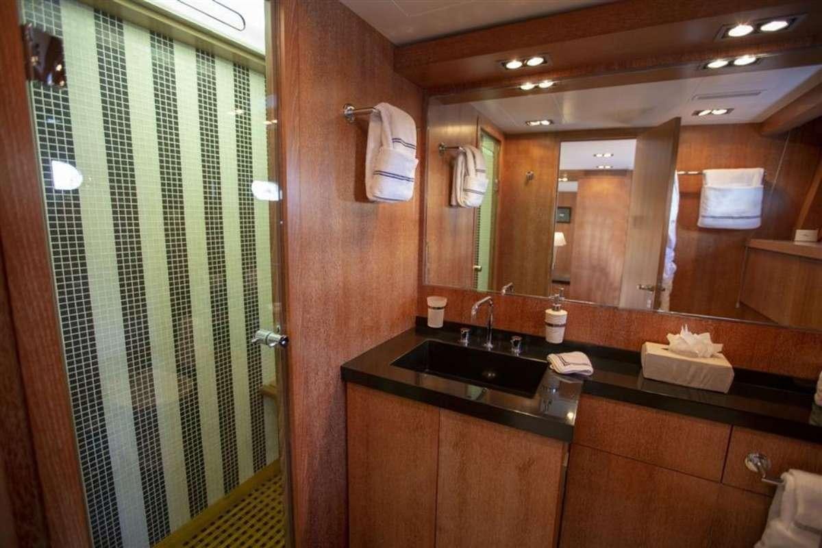 a bathroom with a sink and a mirror aboard EVA Yacht for Charter