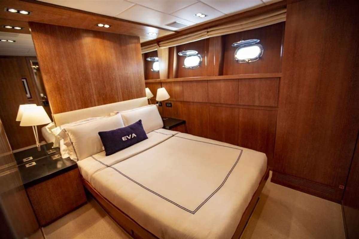 a room with a bed and a desk aboard EVA Yacht for Charter
