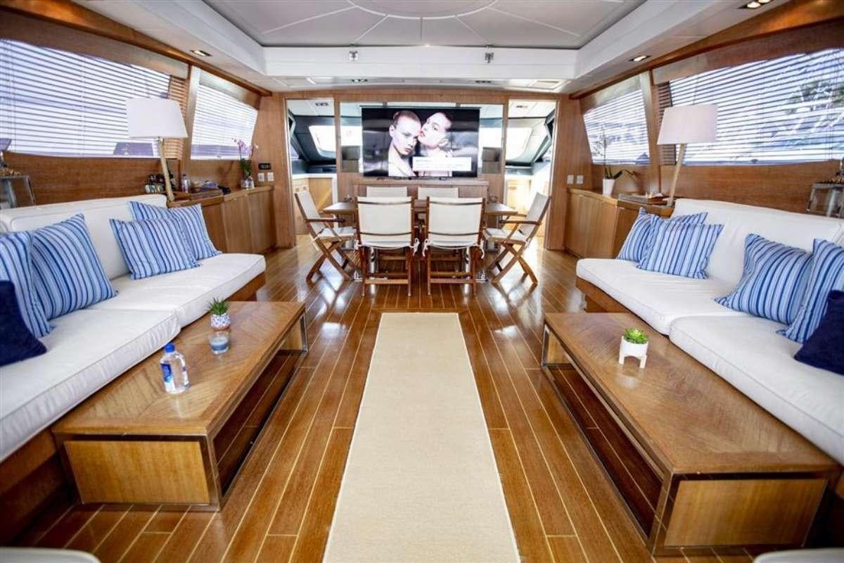a living room with a large screen aboard EVA Yacht for Charter