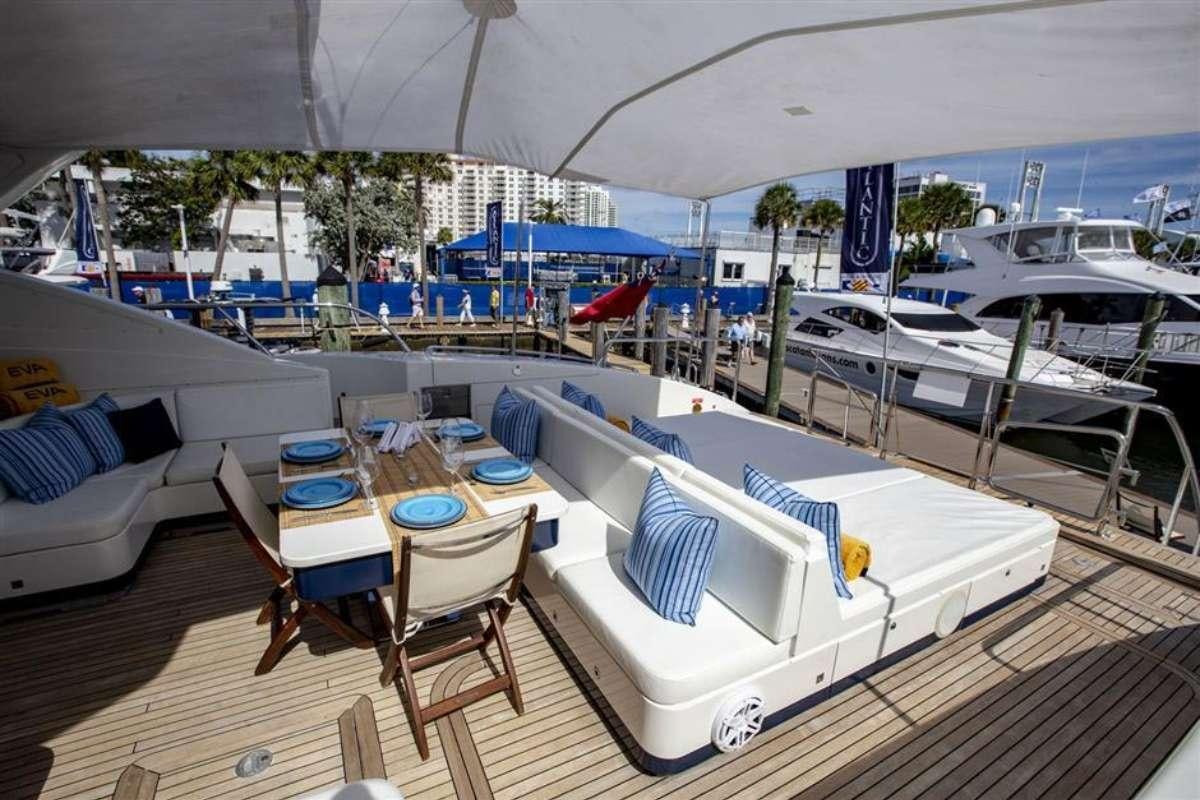 a pool with tables and chairs aboard EVA Yacht for Charter