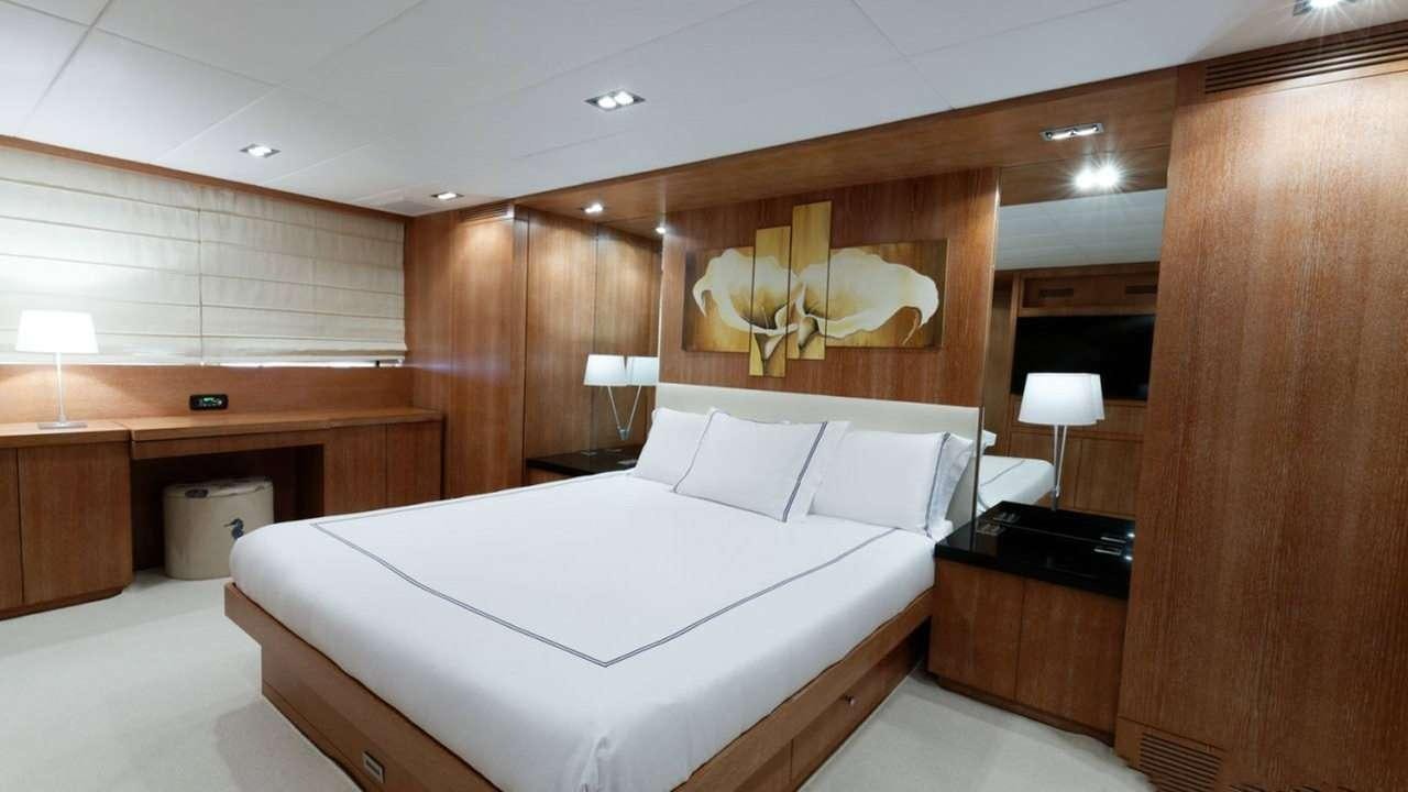 a room with a bed and a desk aboard EVA Yacht for Charter
