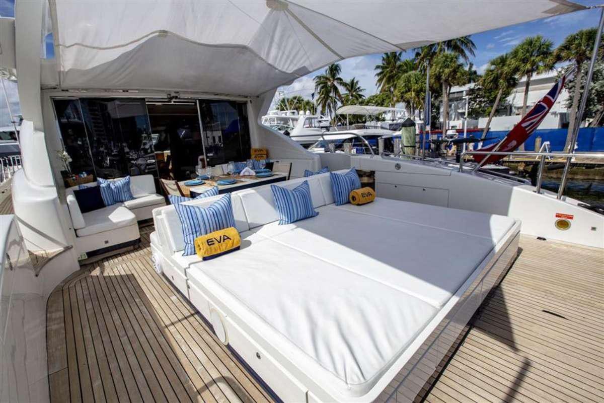 a large white tent with a table and chairs and a beach aboard EVA Yacht for Charter