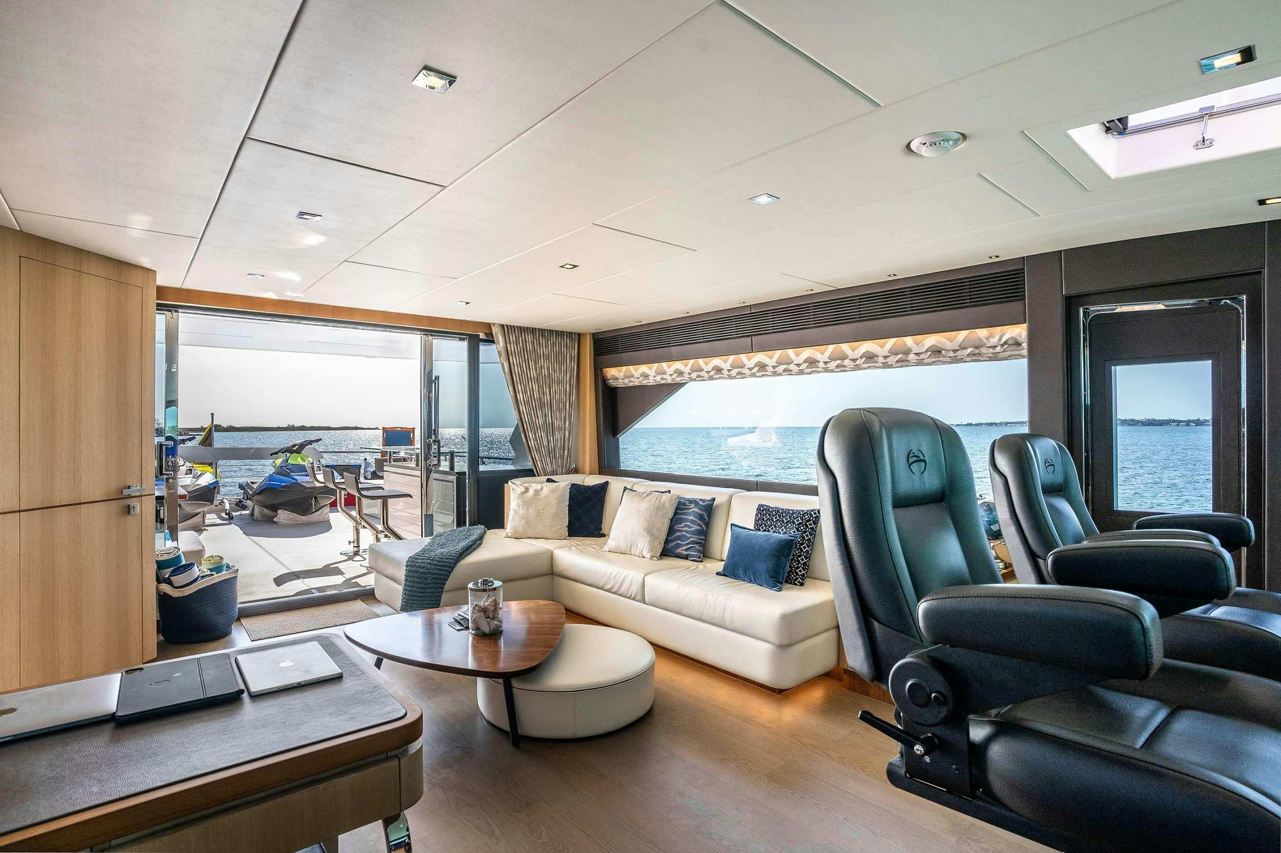 a living room with a large window aboard AQUA LIFE Yacht for Charter