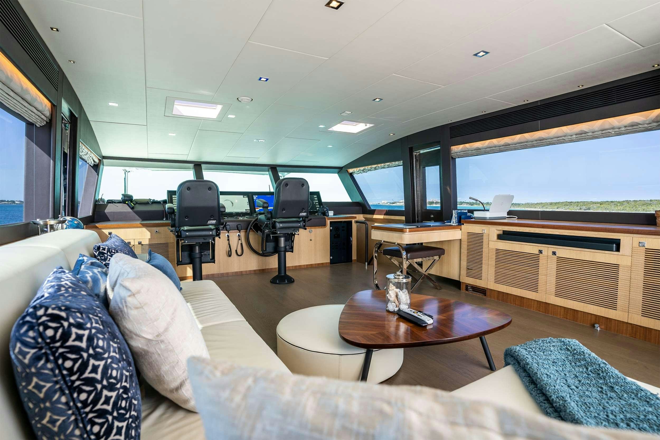 a living room with a couch and a table aboard AQUA LIFE Yacht for Charter