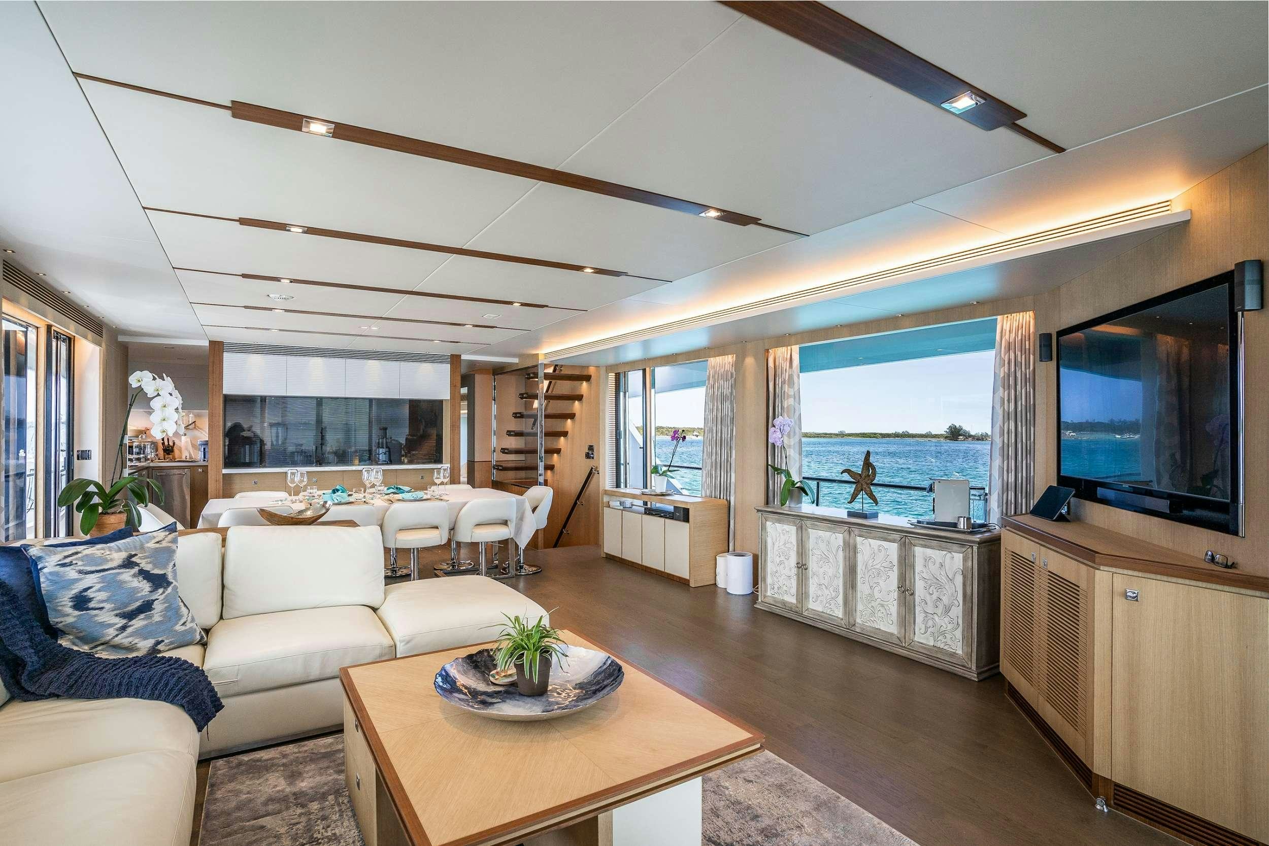 a living room with a large window aboard AQUA LIFE Yacht for Charter