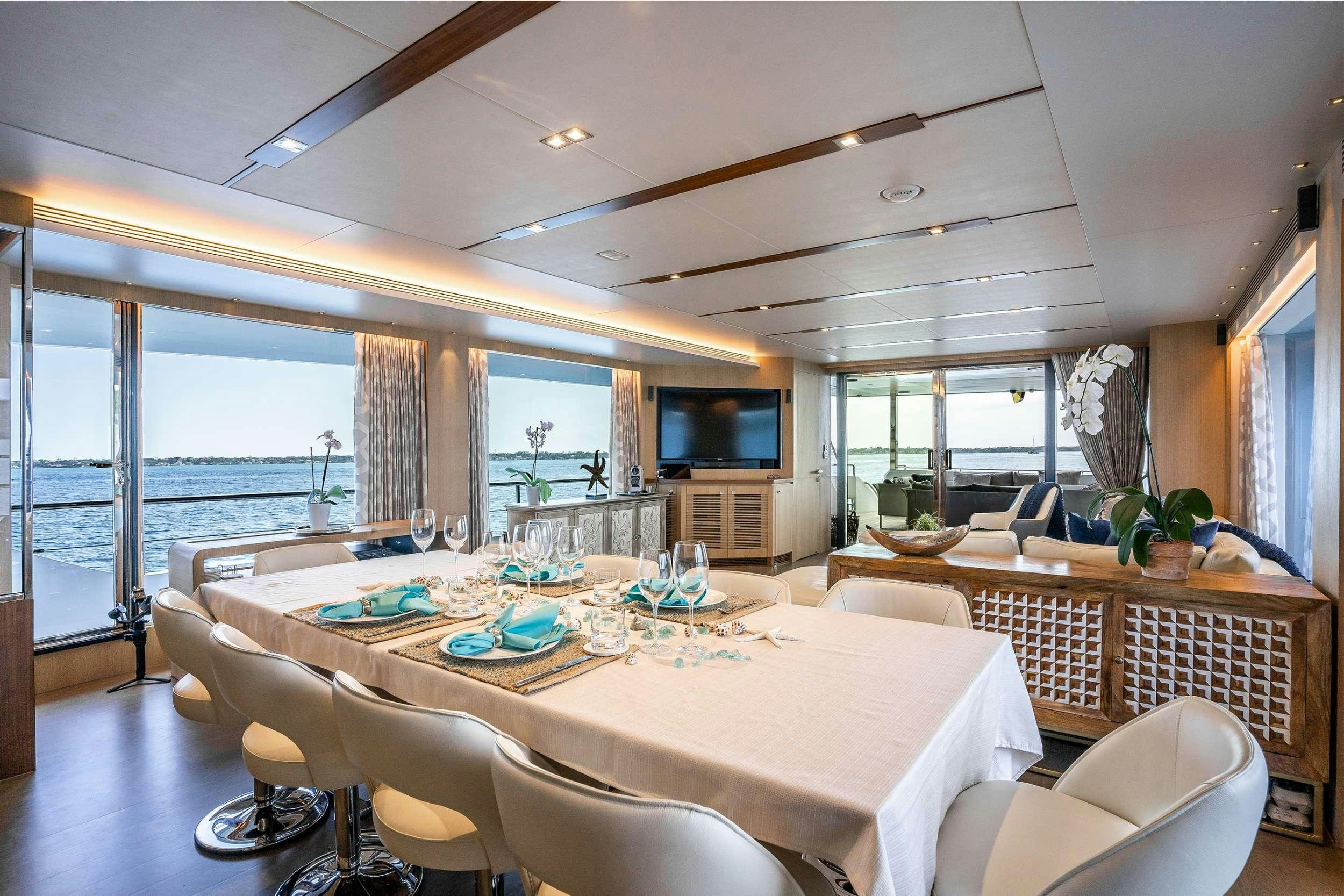 a dining room with a large patio aboard AQUA LIFE Yacht for Charter