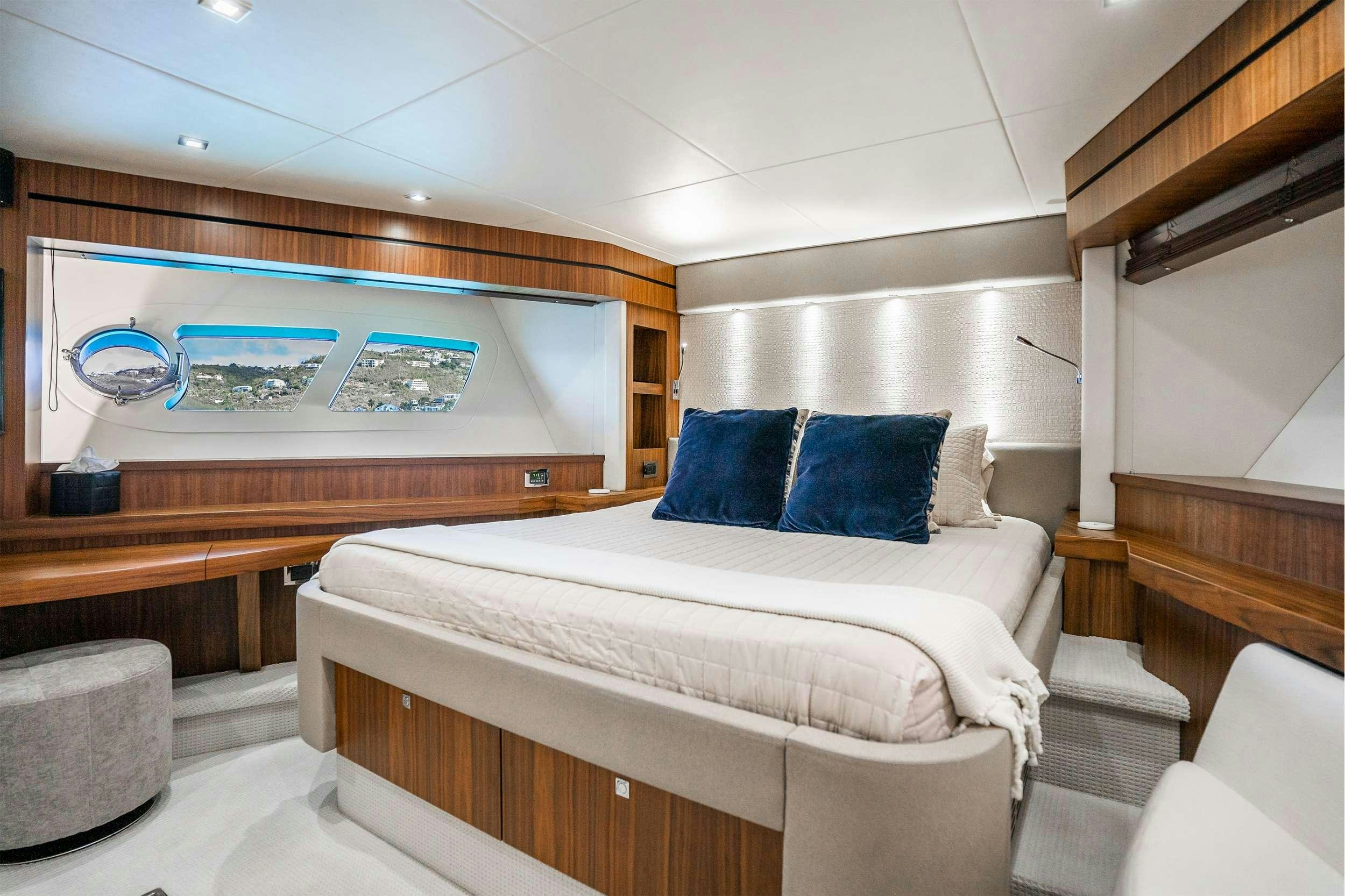 a room with a bed and a television on the wall aboard AQUA LIFE Yacht for Charter