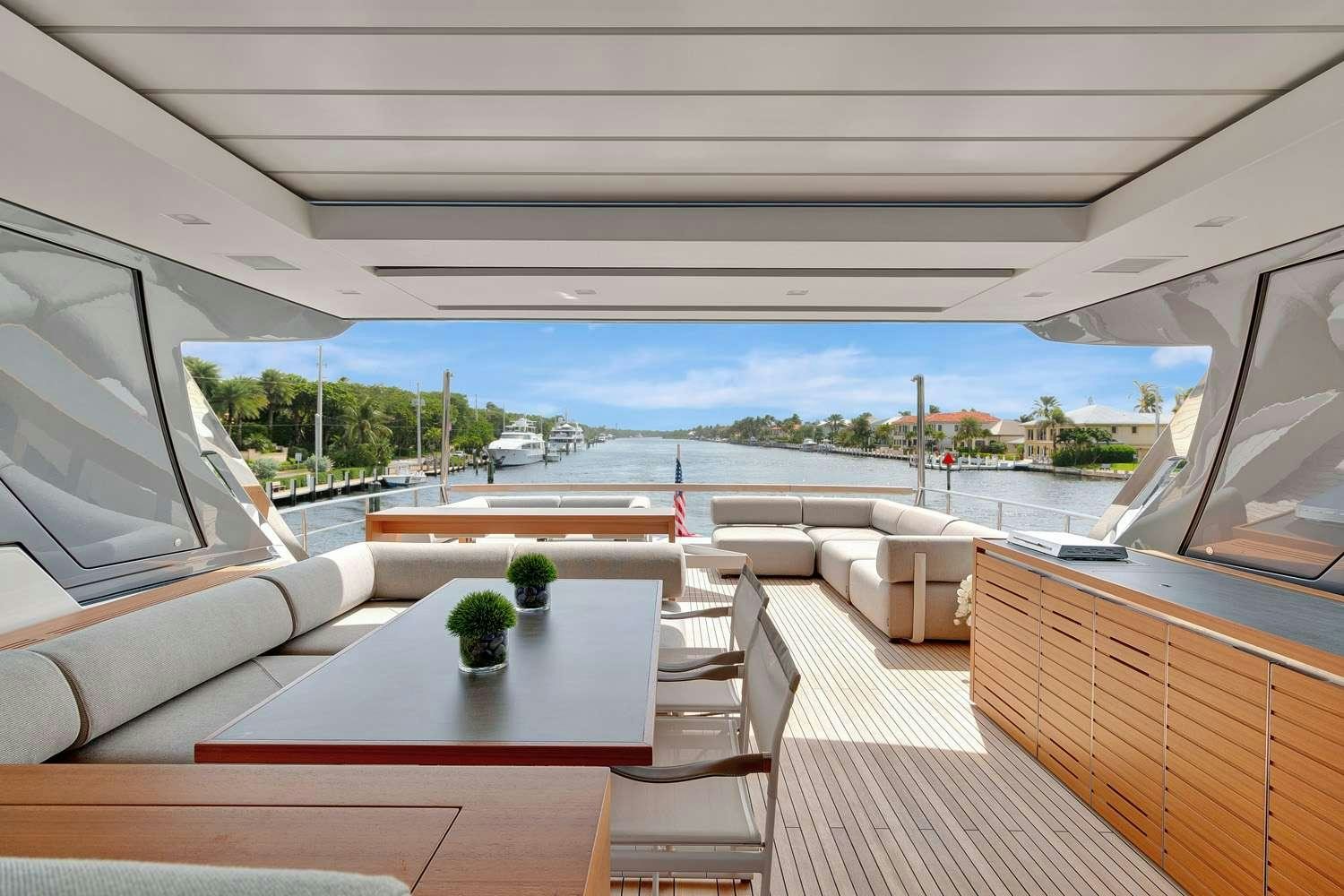a deck with a table and chairs aboard MON CHATEAU Yacht for Charter