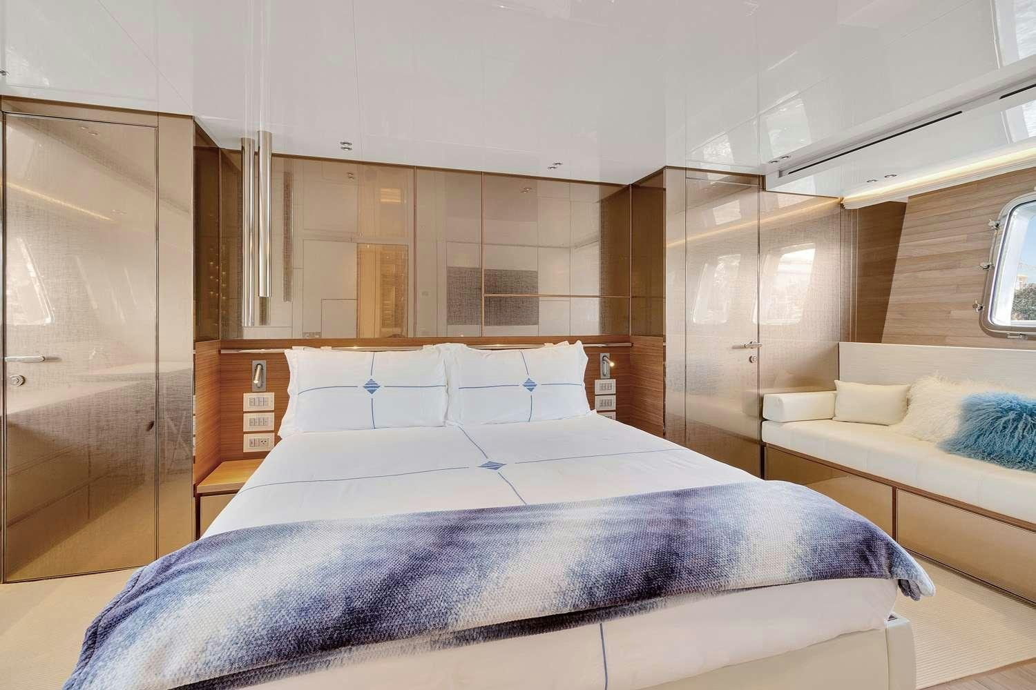 a room with a bed and a desk aboard MON CHATEAU Yacht for Charter