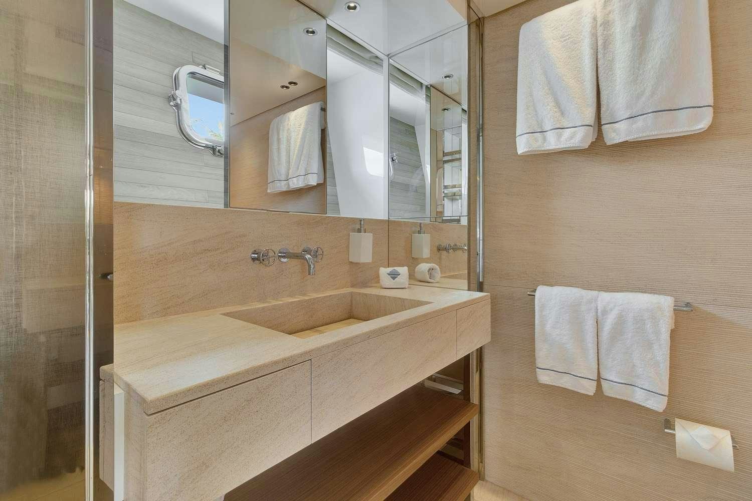 a bathroom with a large mirror aboard MON CHATEAU Yacht for Charter