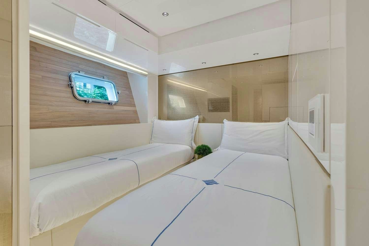 a room with white beds aboard MON CHATEAU Yacht for Charter